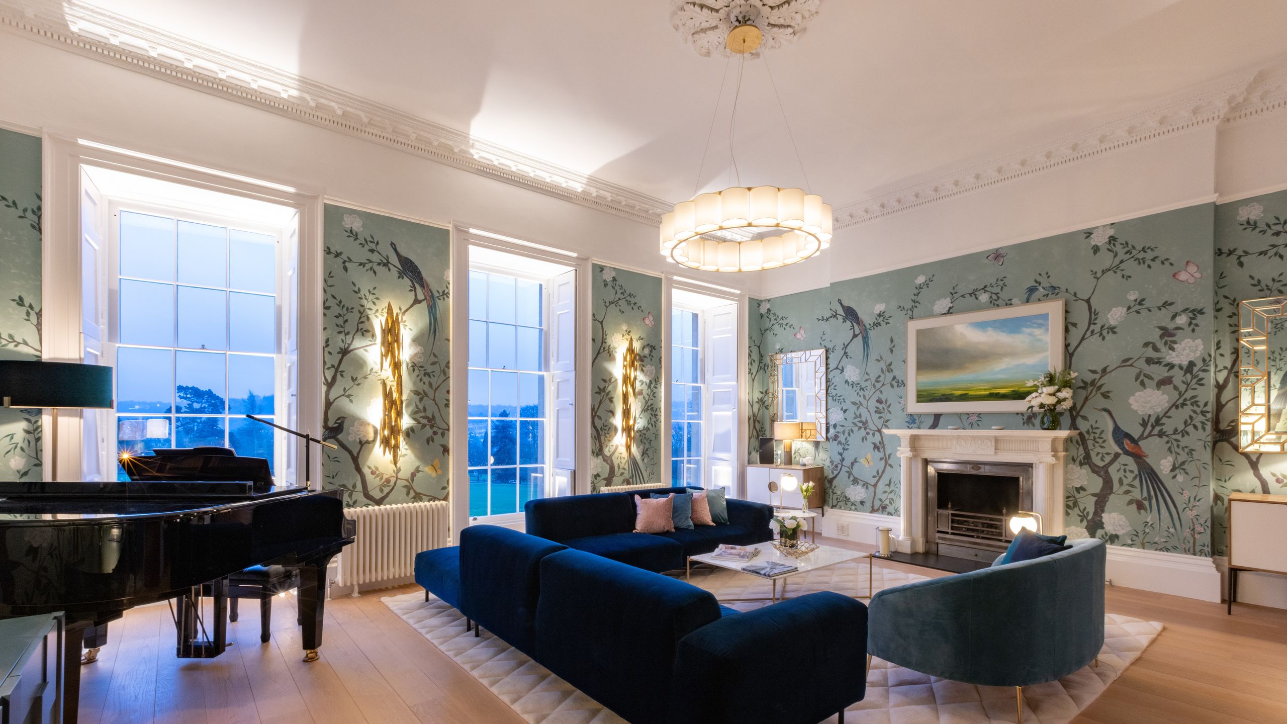 Image may contain: Home Decor, Architecture, Building, Furniture, Indoors, Living Room, Room, Lamp, Rug, Art, and Painting