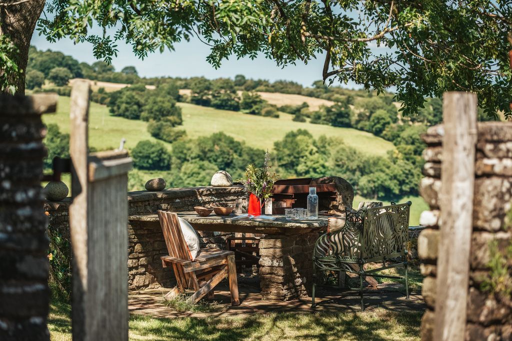 Image may contain Countryside Nature Outdoors Chair Furniture Rural Desk Table Architecture Building and Housing