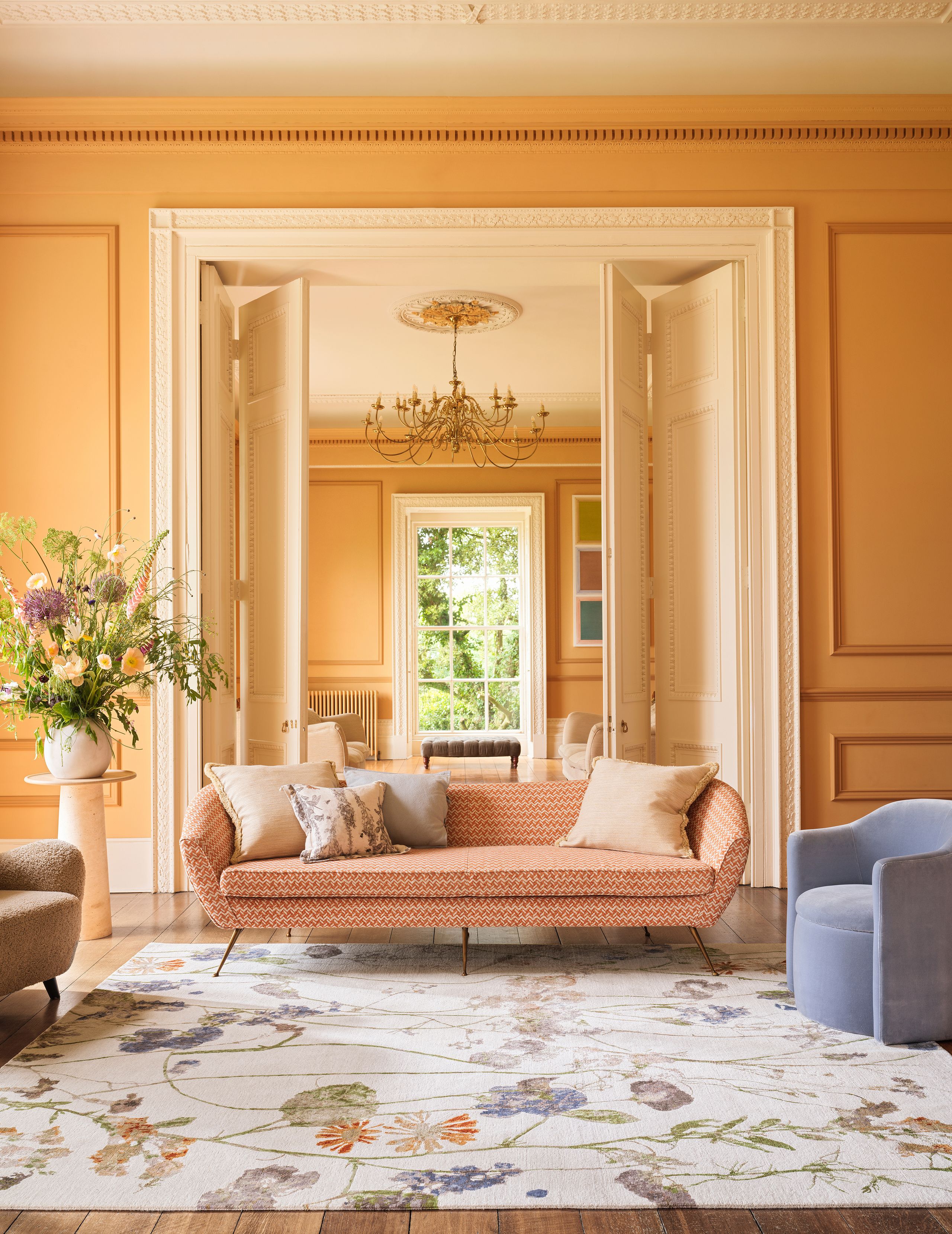 Image may contain: Home Decor, Rug, Indoors, Interior Design, Couch, Furniture, Architecture, Building, Foyer, and Chandelier