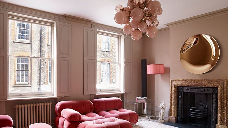 Image may contain: Lamp, Furniture, Home Decor, Person, Couch, Electronics, and Speaker