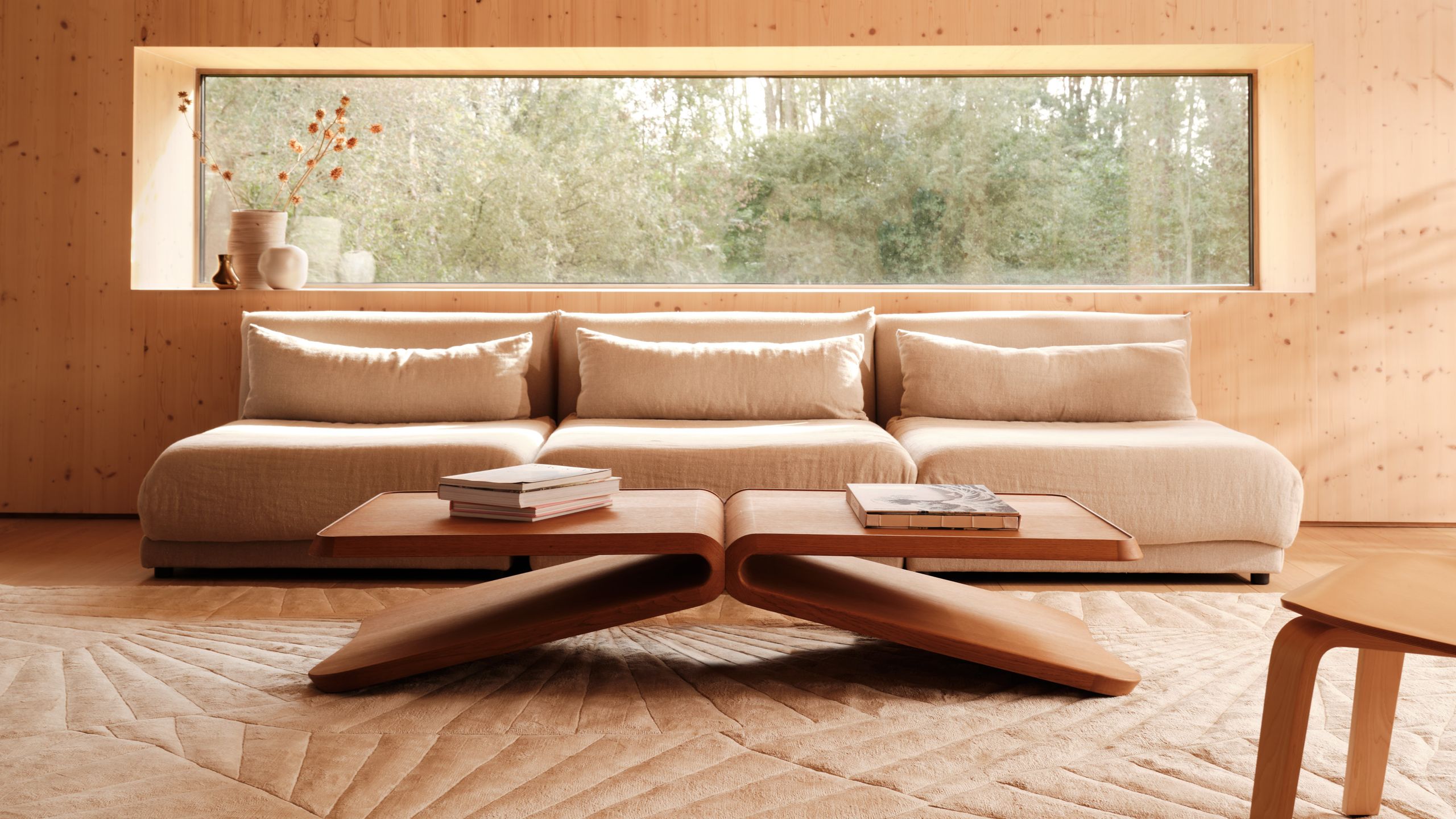 Image may contain: Home Decor, Coffee Table, Furniture, Table, Rug, Indoors, Interior Design, Book, Publication, and Floor