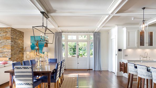 Image may contain: Architecture, Building, Dining Room, Dining Table, Furniture, Indoors, Room, Table, Chandelier, and Lamp