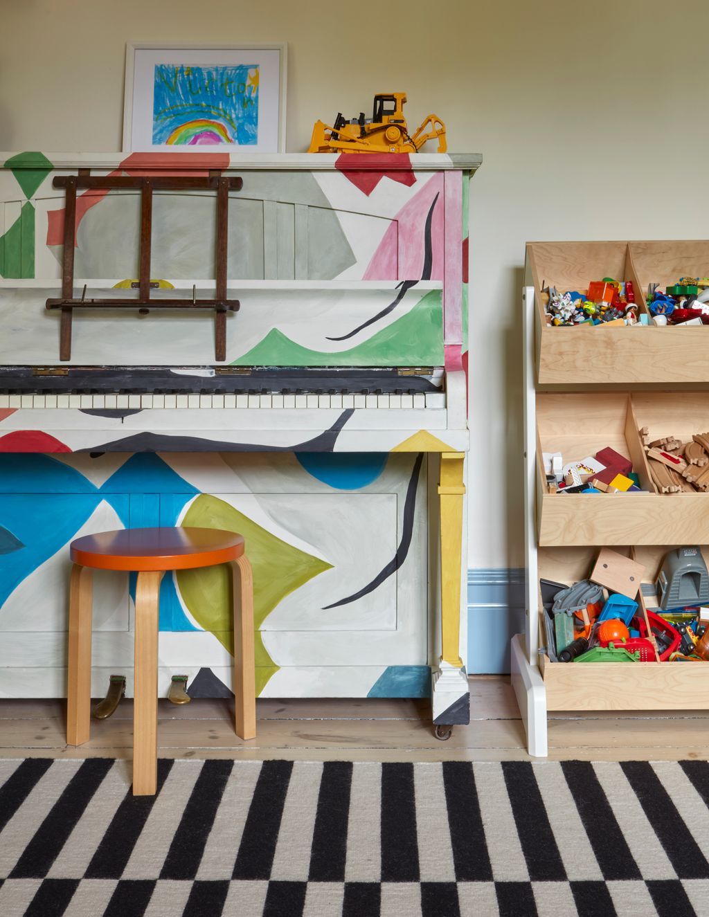 Image may contain Home Decor Art Painting Rug Play Area Box Furniture Keyboard Musical Instrument and Piano