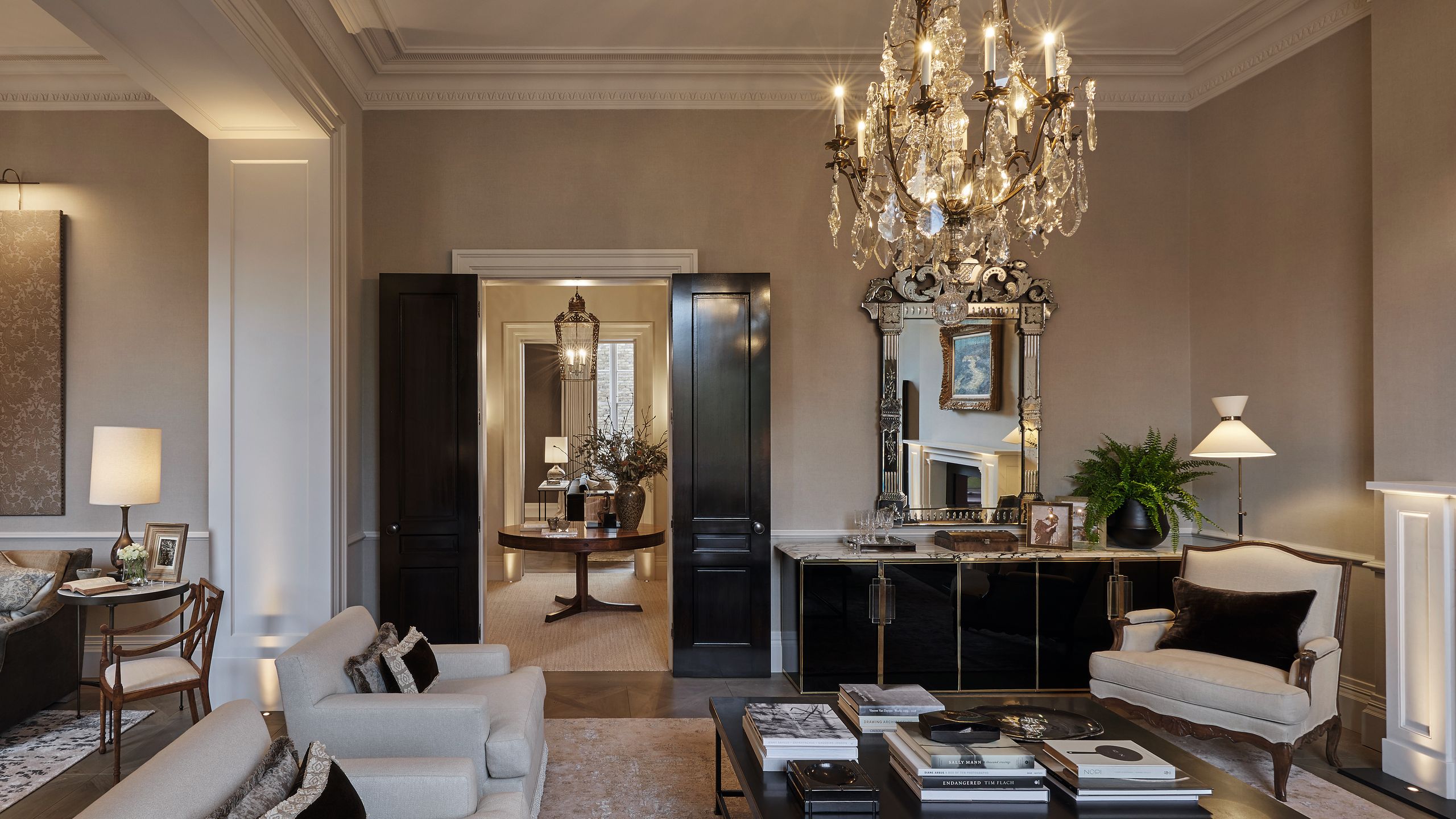 Image may contain: Home Decor, Chandelier, Lamp, Plant, Furniture, Table, Chair, Architecture, Building, and Indoors