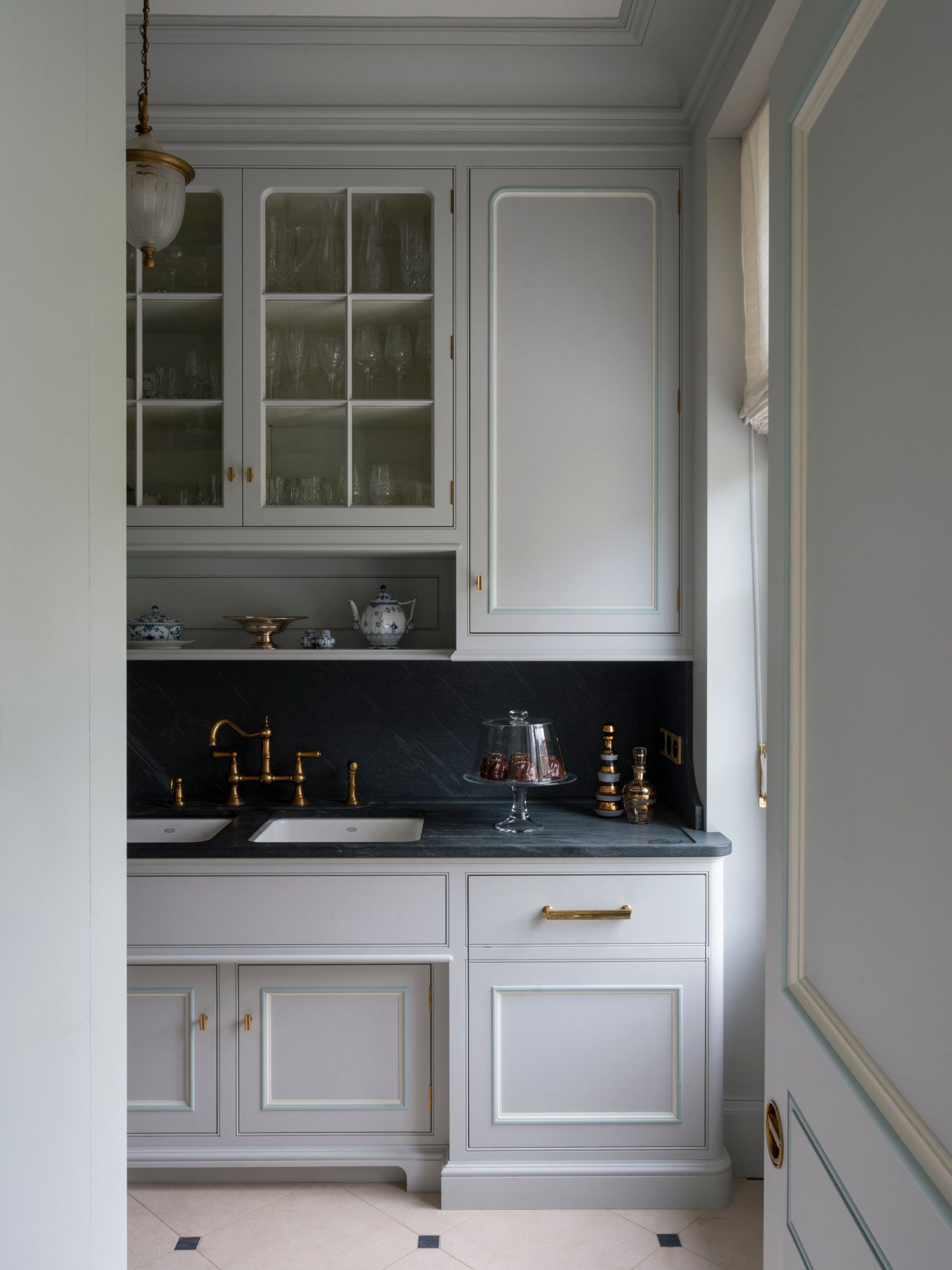 Image may contain: Sink, Sink Faucet, Indoors, Interior Design, Lamp, Furniture, and Kitchen