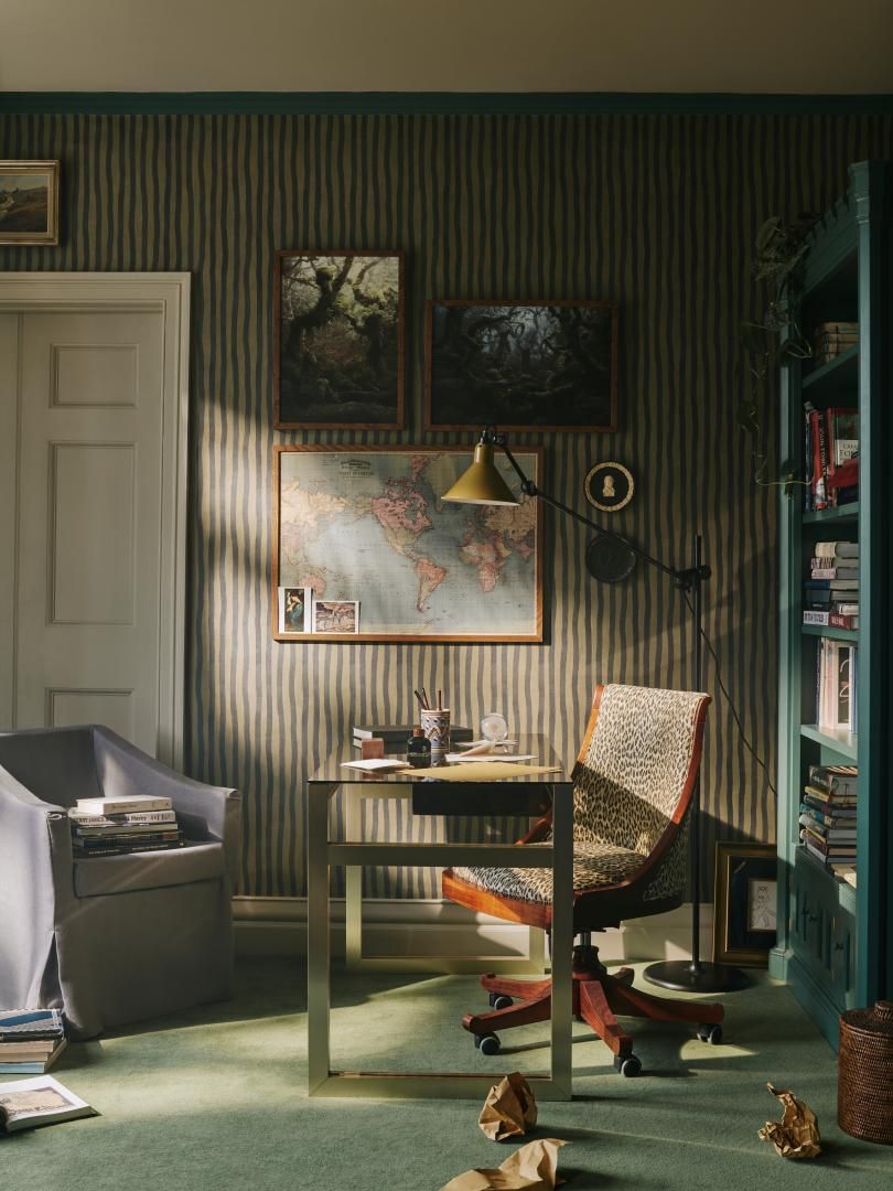 Image may contain: Indoors, Interior Design, Chair, Furniture, Art, Painting, Lamp, Wood Panels, Cup, Table, and Couch