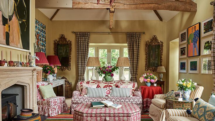 Image may contain: Book, Publication, Home Decor, Lamp, Couch, Furniture, Desk, Table, Art, Painting, Person, Rug, and Chair