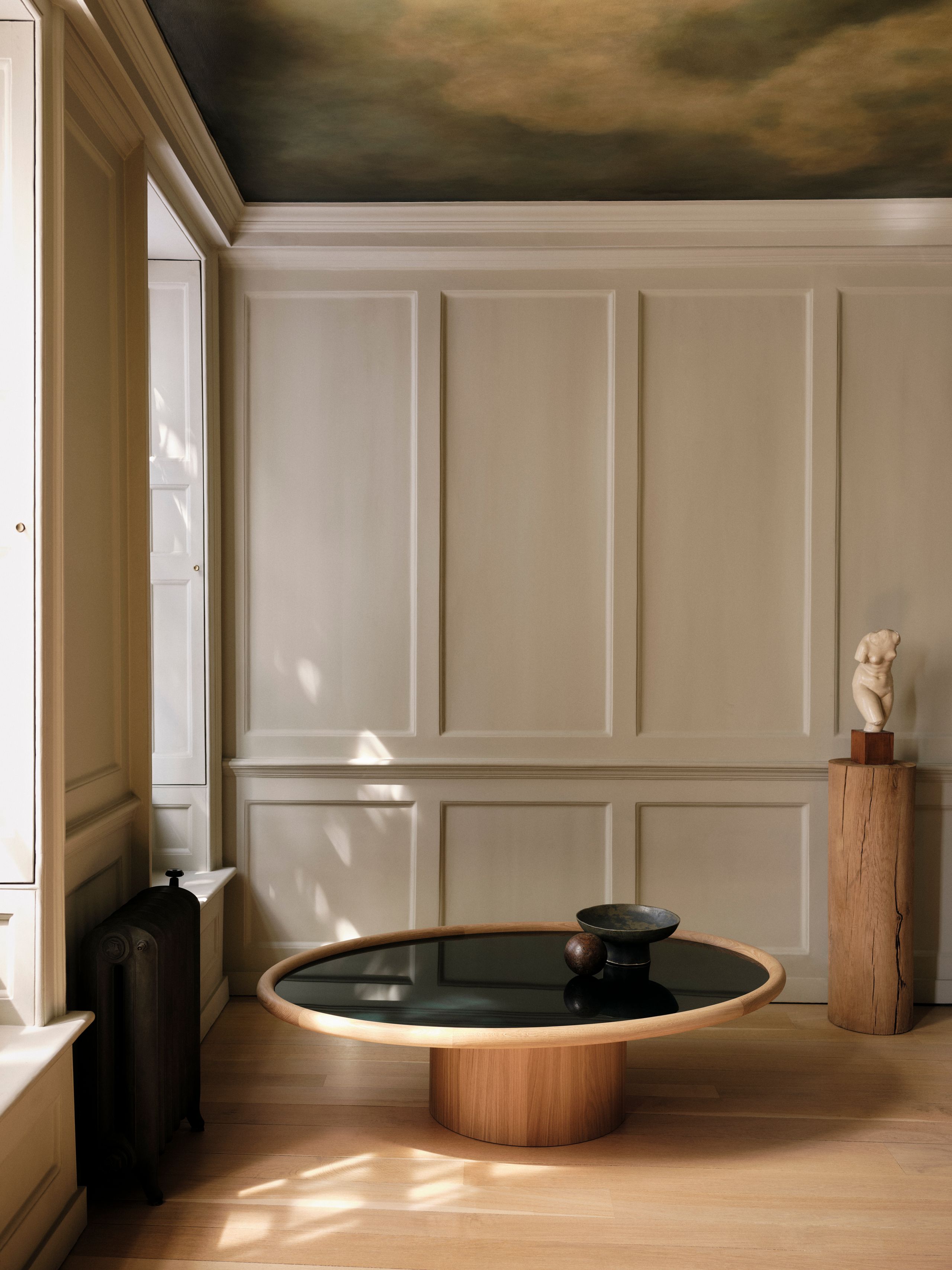 Image may contain: Indoors, Interior Design, Coffee Table, Furniture, Table, Tabletop, Person, and Tub