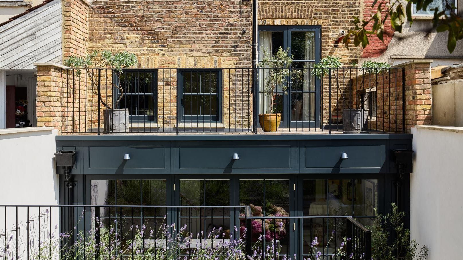 Image may contain: Plant, City, Architecture, Balcony, and Building