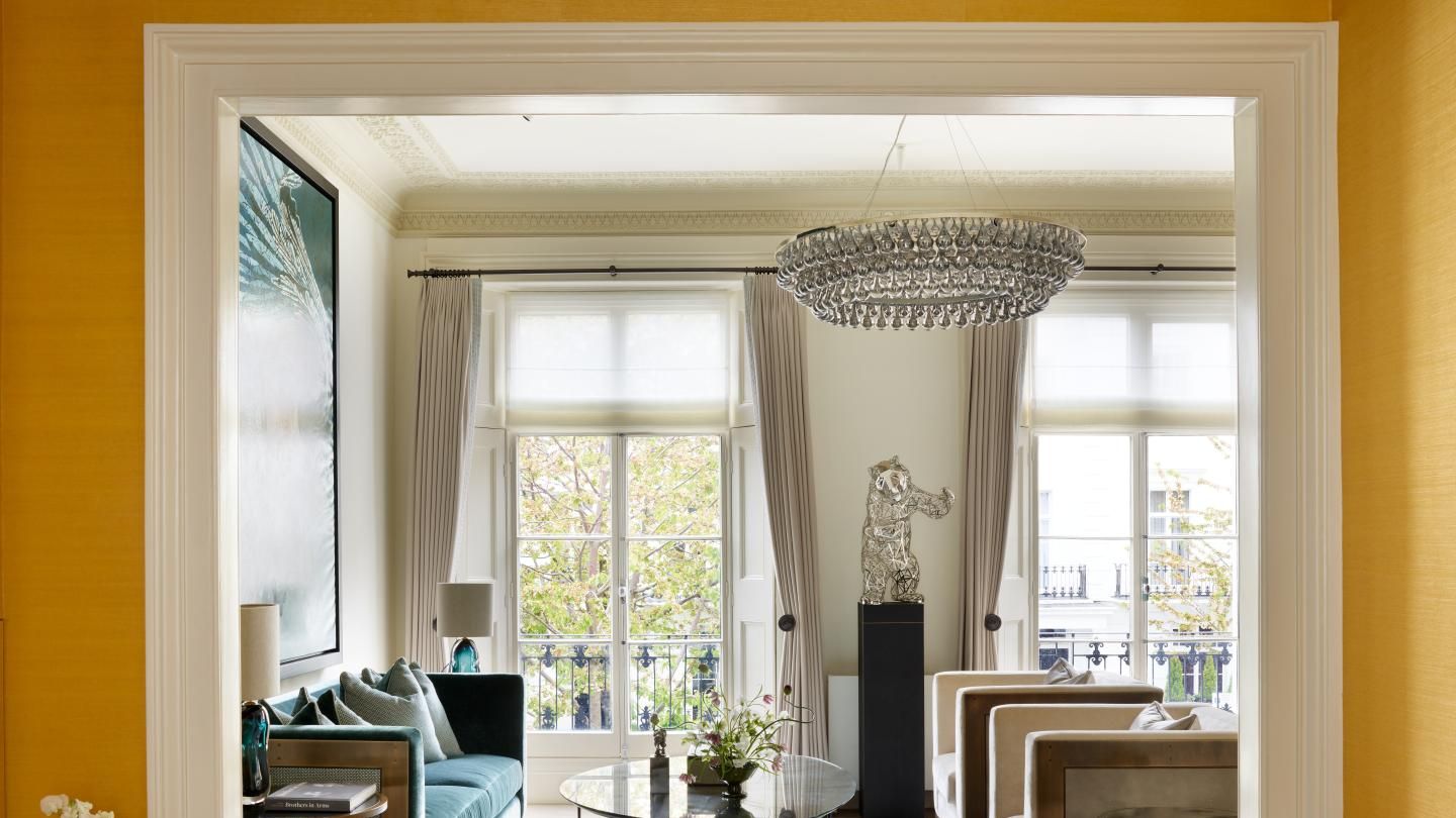 Image may contain: Lamp, Couch, Furniture, Home Decor, Table, Architecture, Building, Indoors, Living Room, Room, and Door