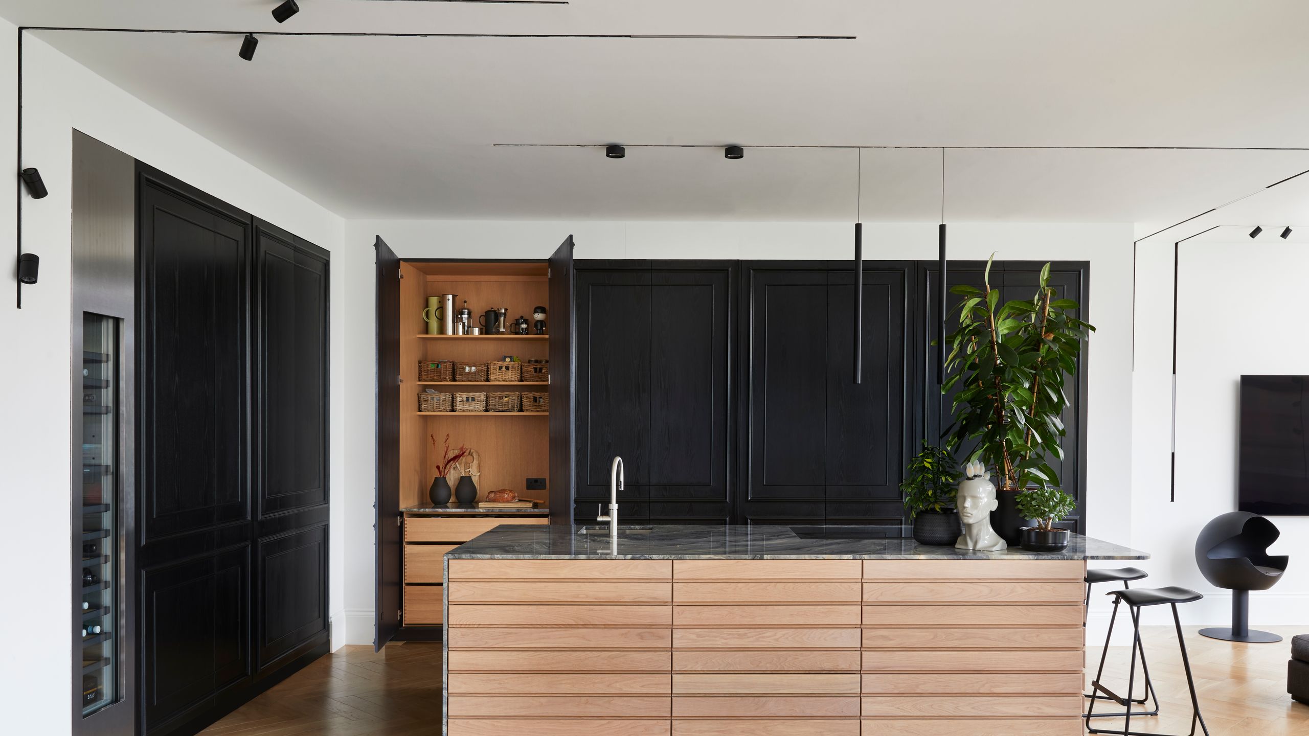 Image may contain: Indoors, Interior Design, Wood, Plant, Kitchen, Floor, Chair, Furniture, Person, and Home Decor