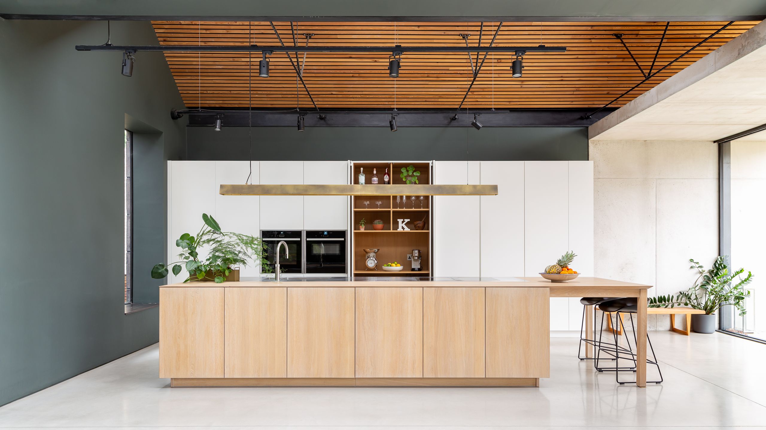 Image may contain: Indoors, Interior Design, Plant, Kitchen, Floor, Wood, Lamp, Furniture, and Table