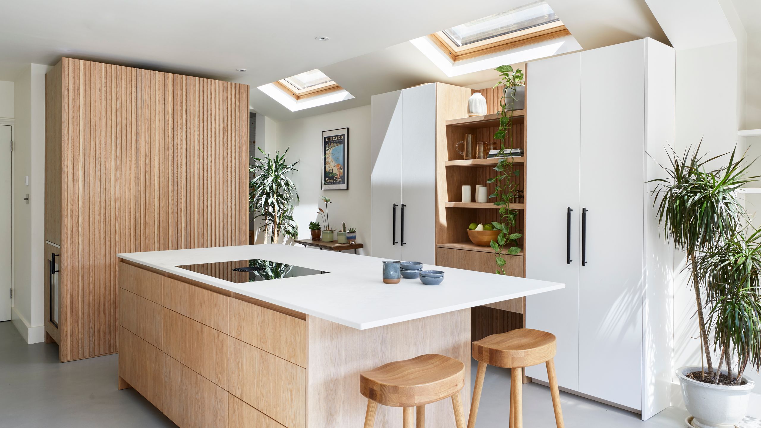 Image may contain: Indoors, Interior Design, Kitchen, Bar Stool, Furniture, Kitchen Island, and Plant