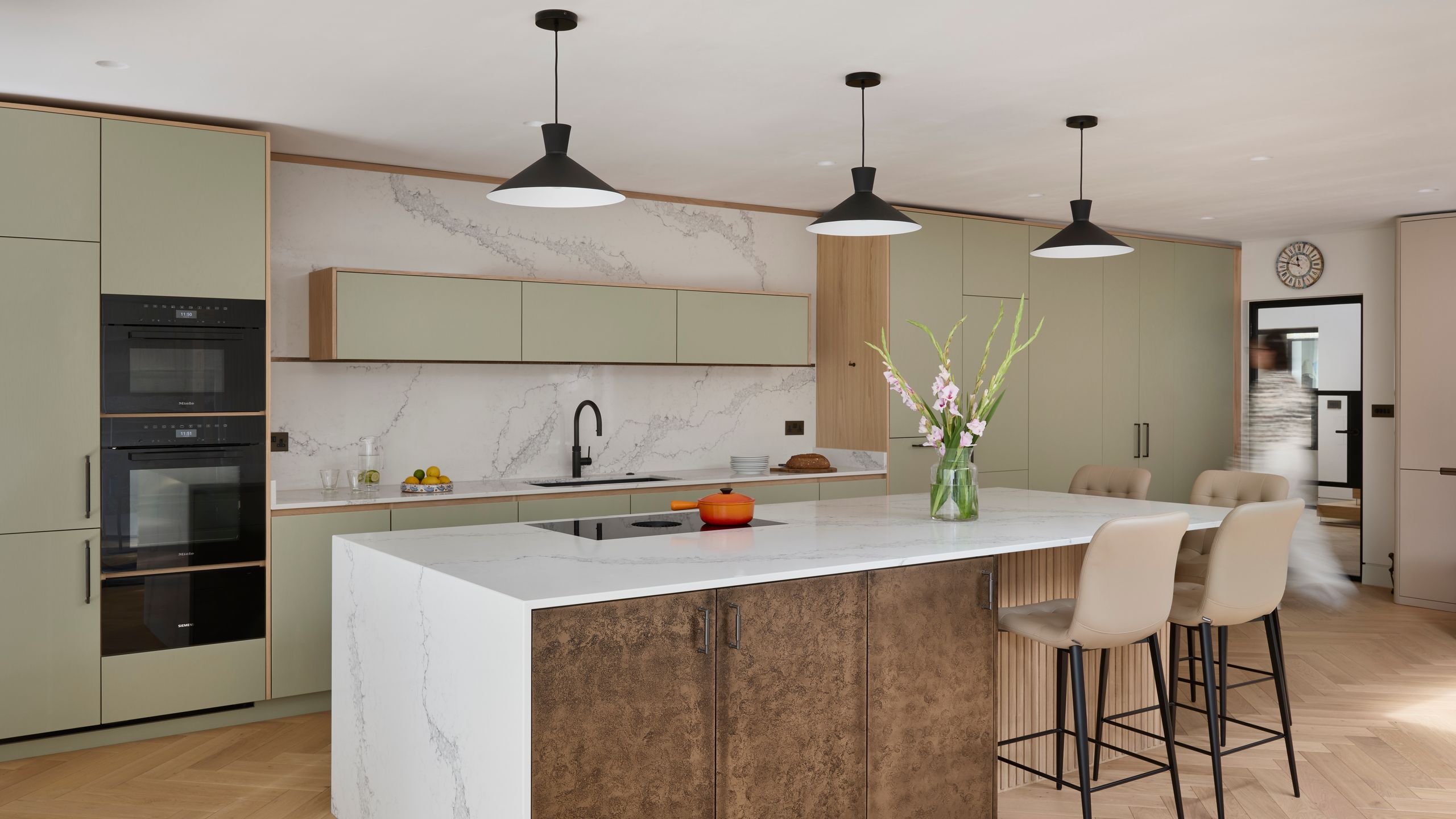 Image may contain: Indoors, Interior Design, Kitchen, Kitchen Island, and Person