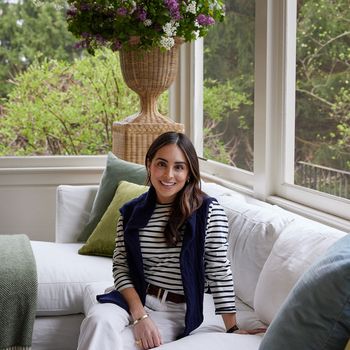 Image may contain: Accessories, Belt, Couch, Furniture, Bracelet, Jewelry, Plant, Potted Plant, Adult, Person, and Sitting