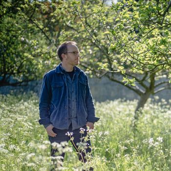 Image may contain: Clothing, Pants, Person, Standing, Adult, Accessories, Glasses, Plant, Vegetation, Sleeve, and Jeans