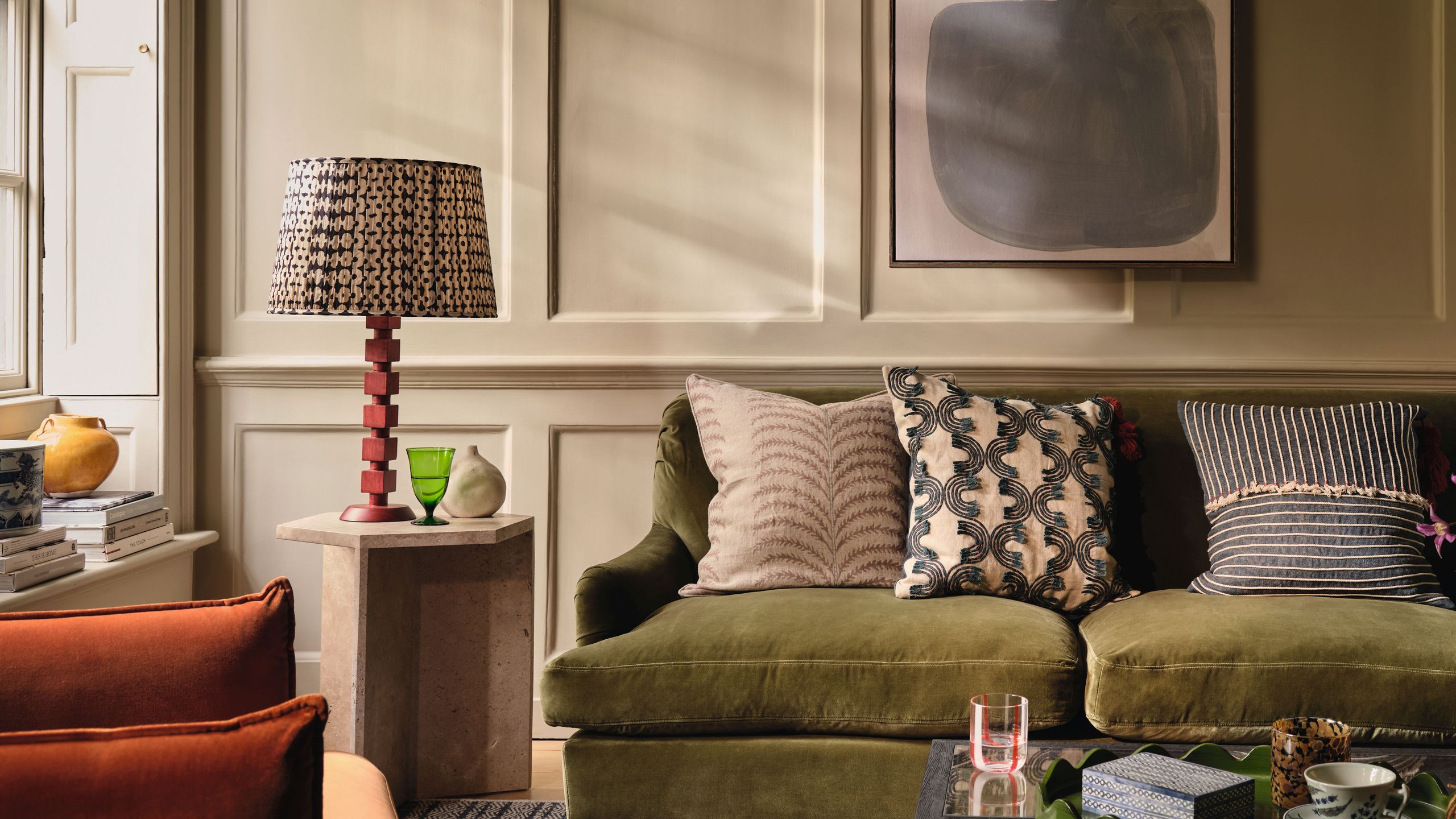 Image may contain: Cushion, Home Decor, Couch, Furniture, Lamp, Cup, Architecture, Building, Indoors, Living Room, and Room