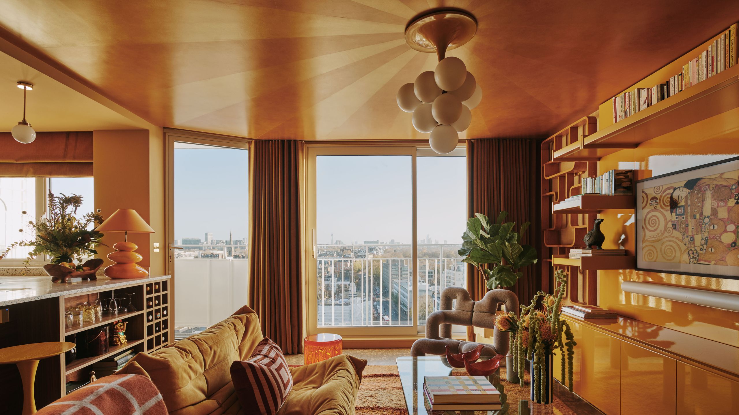 Image may contain: Architecture, Building, Furniture, Indoors, Living Room, Room, Home Decor, Lamp, Book, and Publication