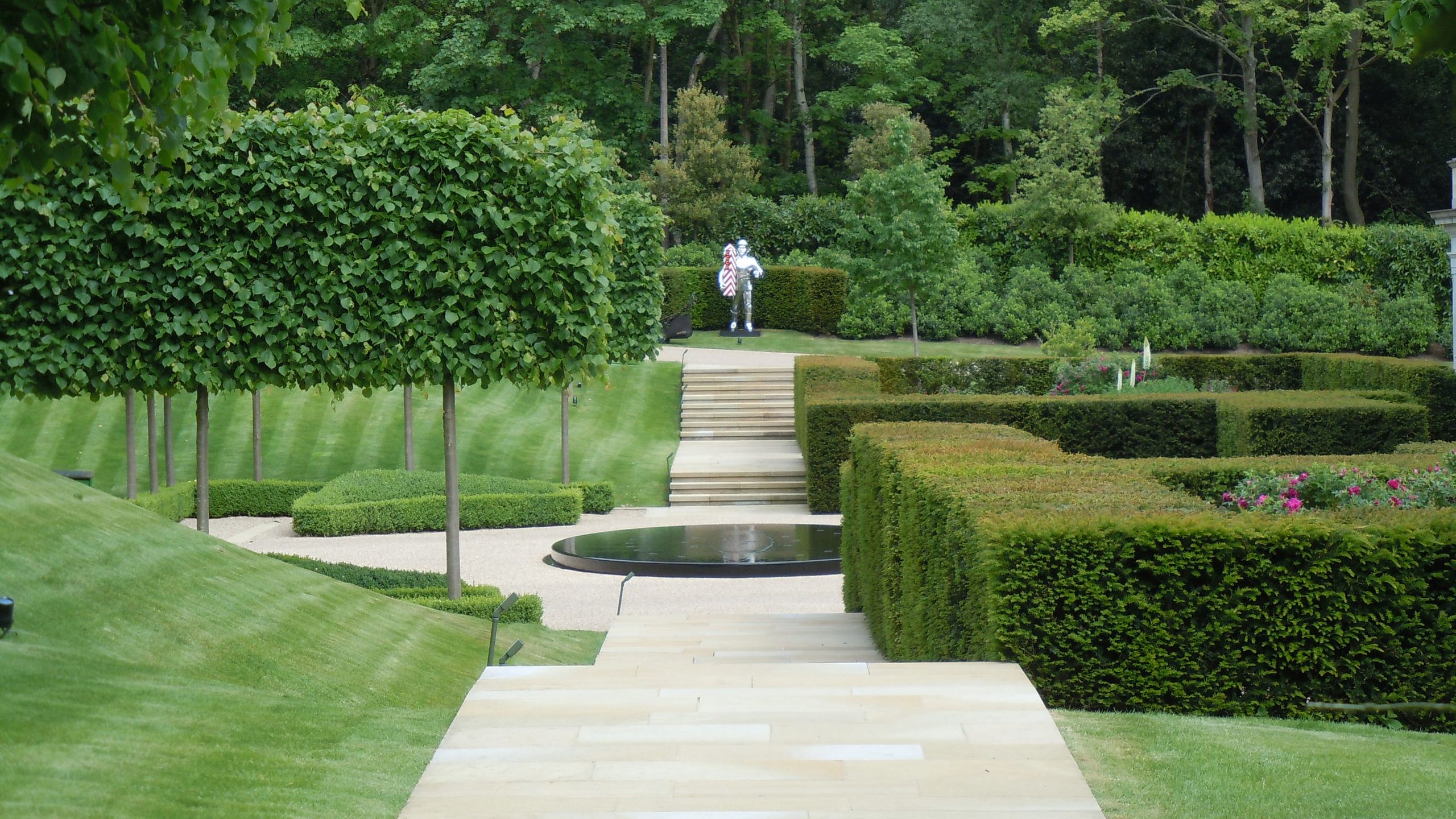 Image may contain: Grass, Nature, Outdoors, Park, Plant, Garden, Fence, Hedge, Backyard, Yard, Person, Vegetation, and Lawn