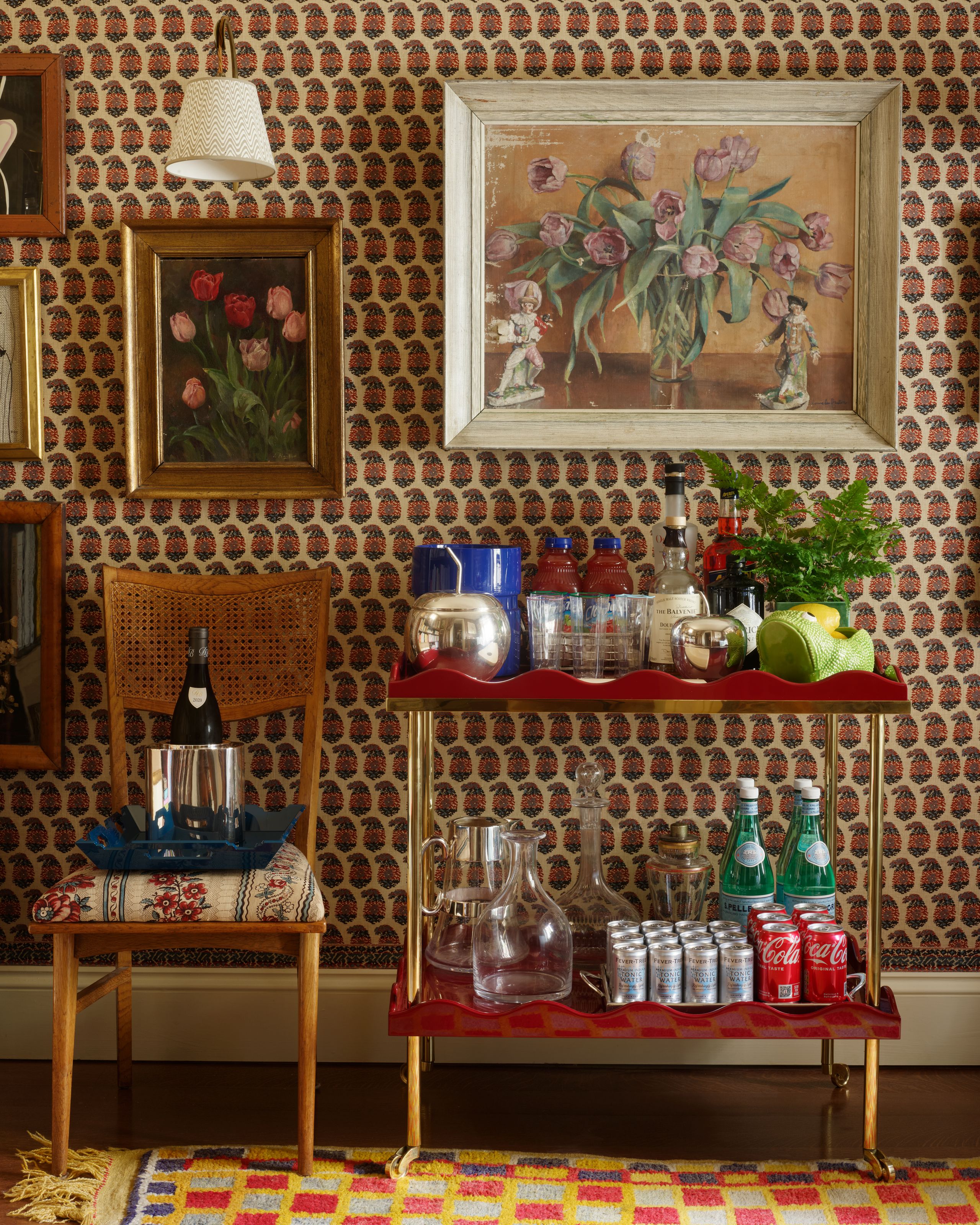 Image may contain: Shelf, Indoors, Interior Design, Chair, Furniture, Art, Painting, Home Decor, Rug, and Person