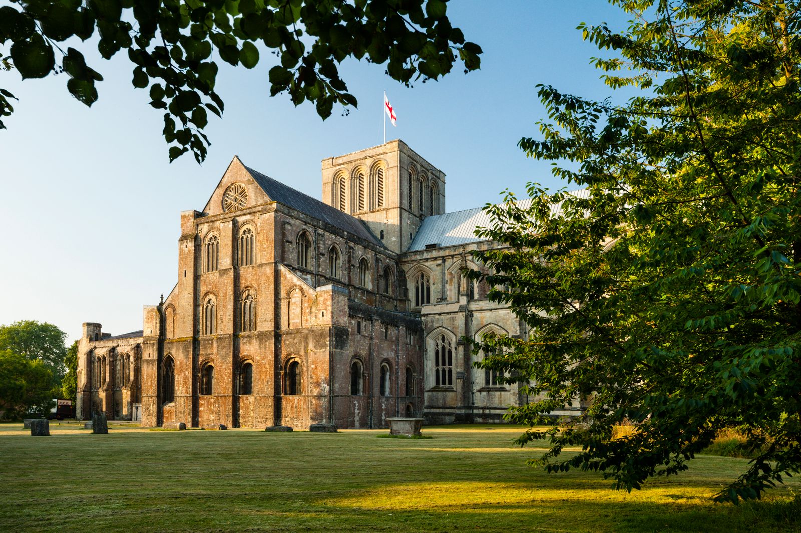 Image may contain Arch Architecture Gothic Arch Grass Plant Flag Building Monastery Cathedral Church and Lawn