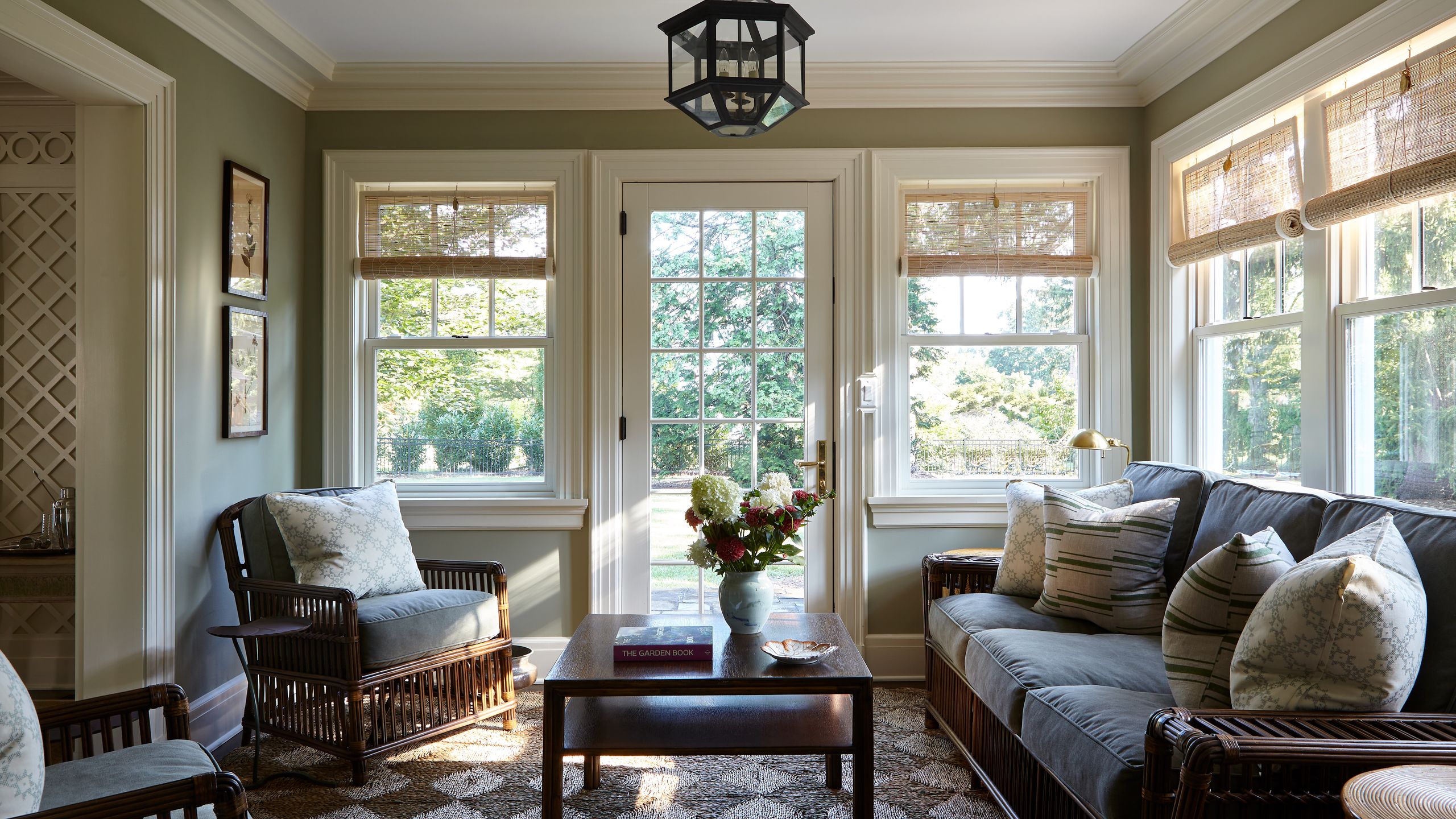 Image may contain: Couch, Furniture, Chair, French Window, Window, Lamp, Plate, Home Decor, Rug, Book, and Publication