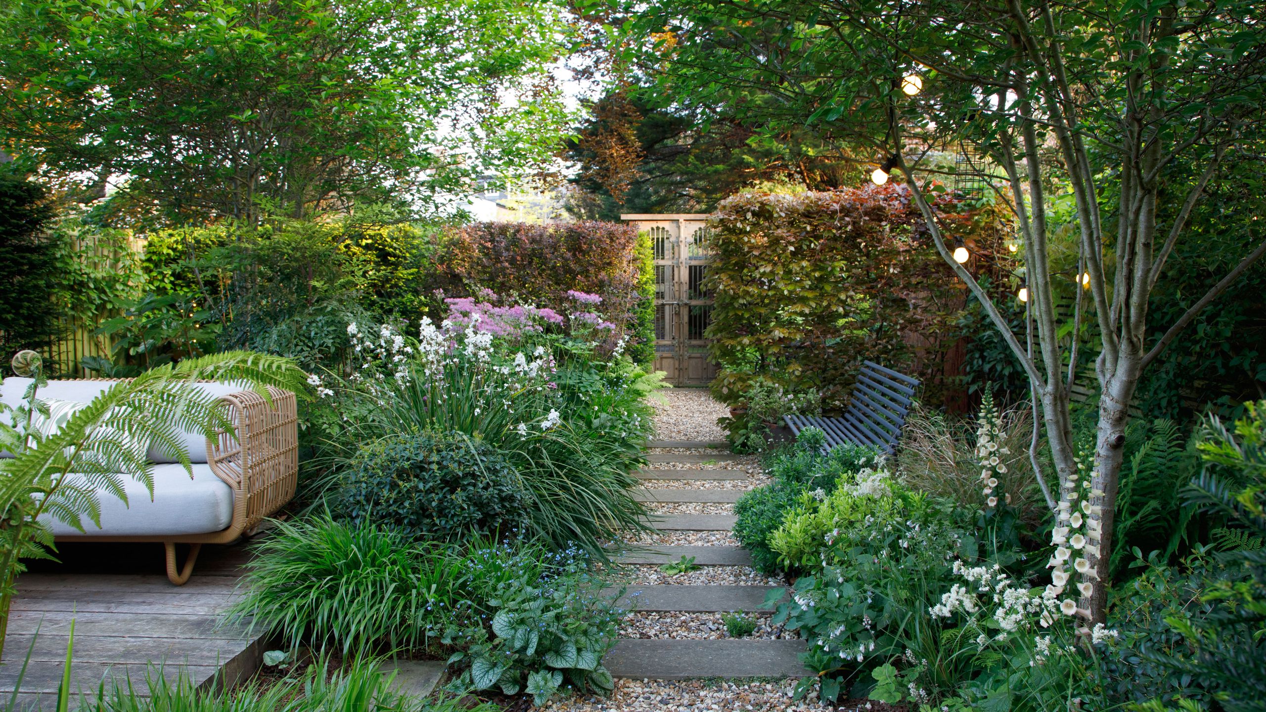 Image may contain: Garden, Nature, Outdoors, Backyard, Yard, Plant, Vegetation, Bench, Furniture, Grass, Path, Tree, and Park