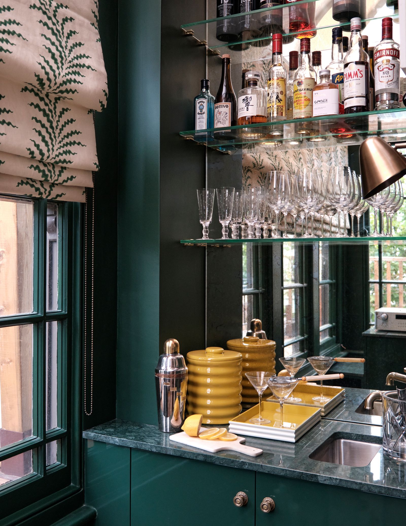 Image may contain Sink Person Cup Shelf Bottle Shaker and Lamp