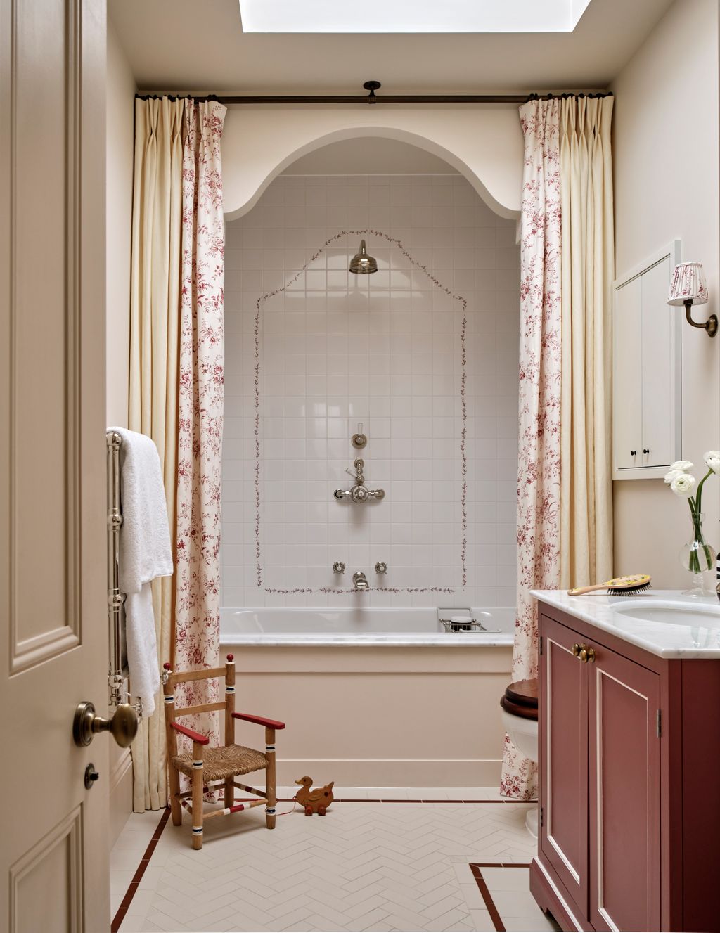 Image may contain Chair Furniture Indoors Interior Design Sink Sink Faucet Bathing Bathtub Person Tub and Lamp