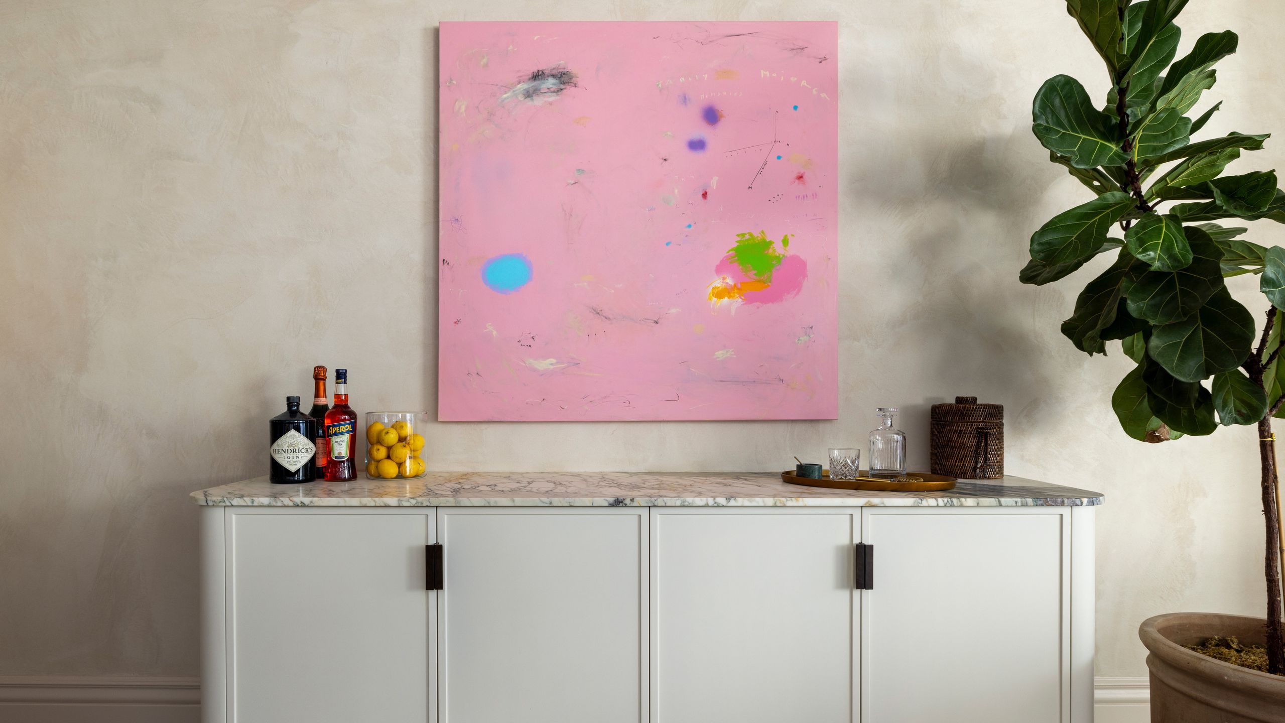 Image may contain: Indoors, Interior Design, Furniture, Sideboard, Plant, Potted Plant, and Cup