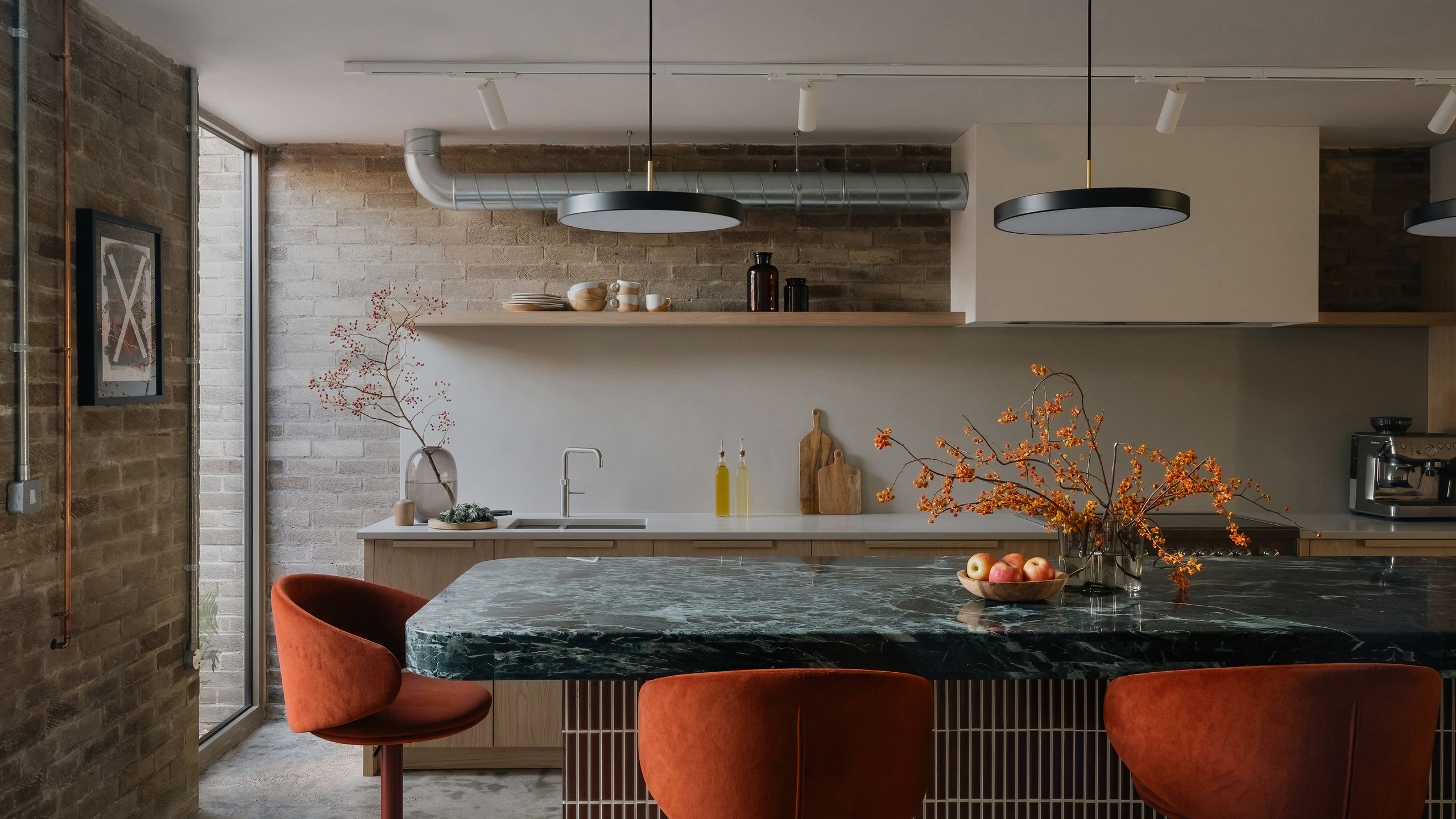 Image may contain: Indoors, Interior Design, Chair, Furniture, Kitchen, Lamp, Sink, Sink Faucet, Dining Table, and Table