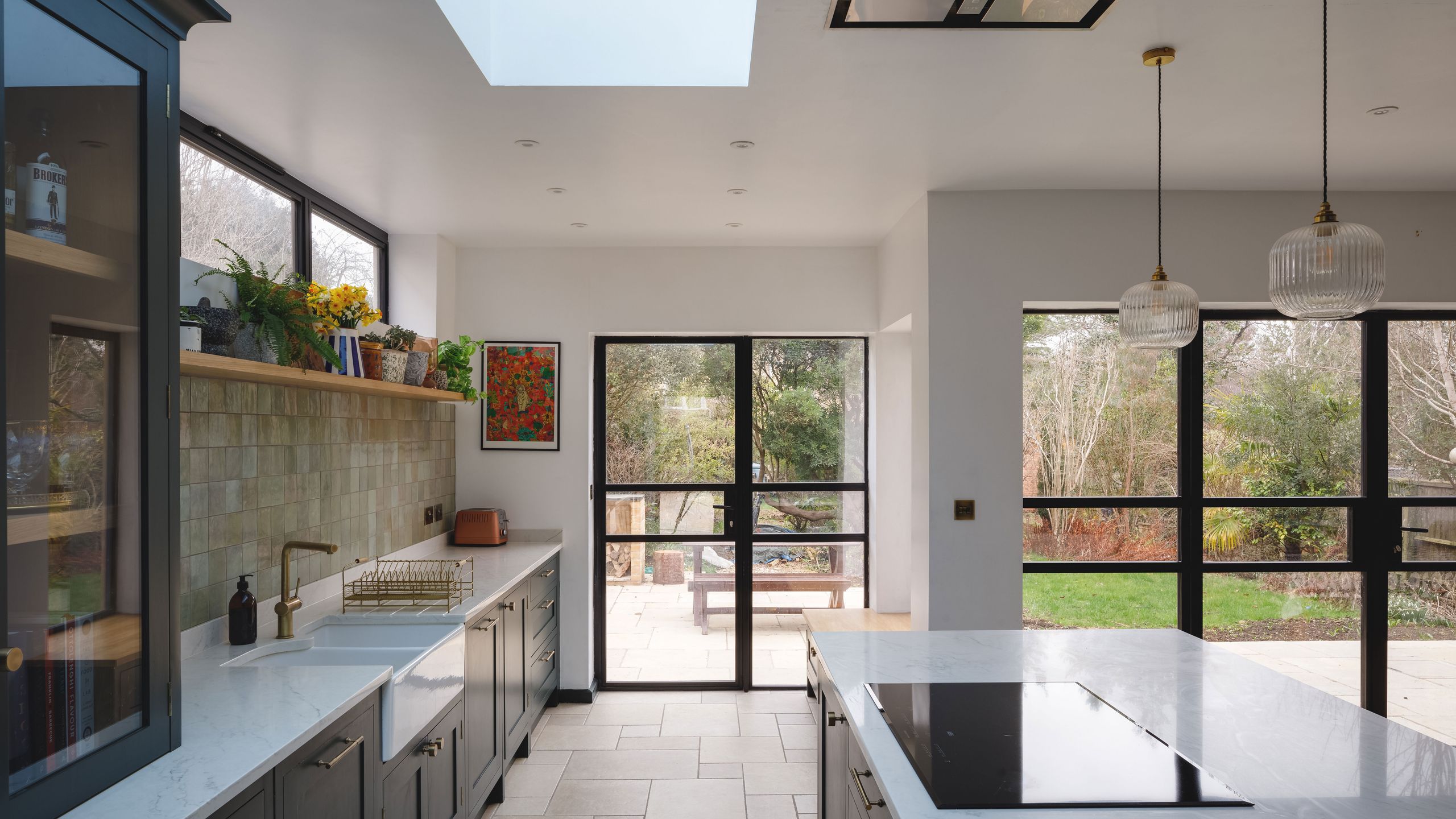 Image may contain: Indoors, Interior Design, Lamp, Kitchen, Plant, Sink, Sink Faucet, Window, Bench, Furniture, and Art