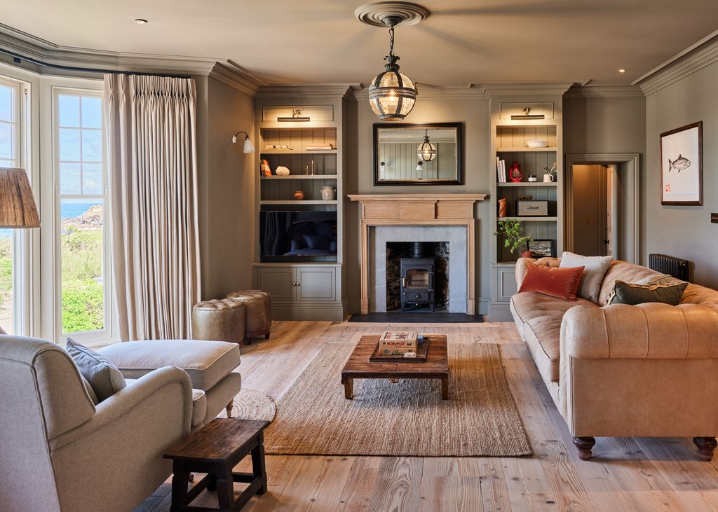 Image may contain Home Decor Couch Furniture Lamp Table Art Painting Rug Indoors Interior Design and Architecture