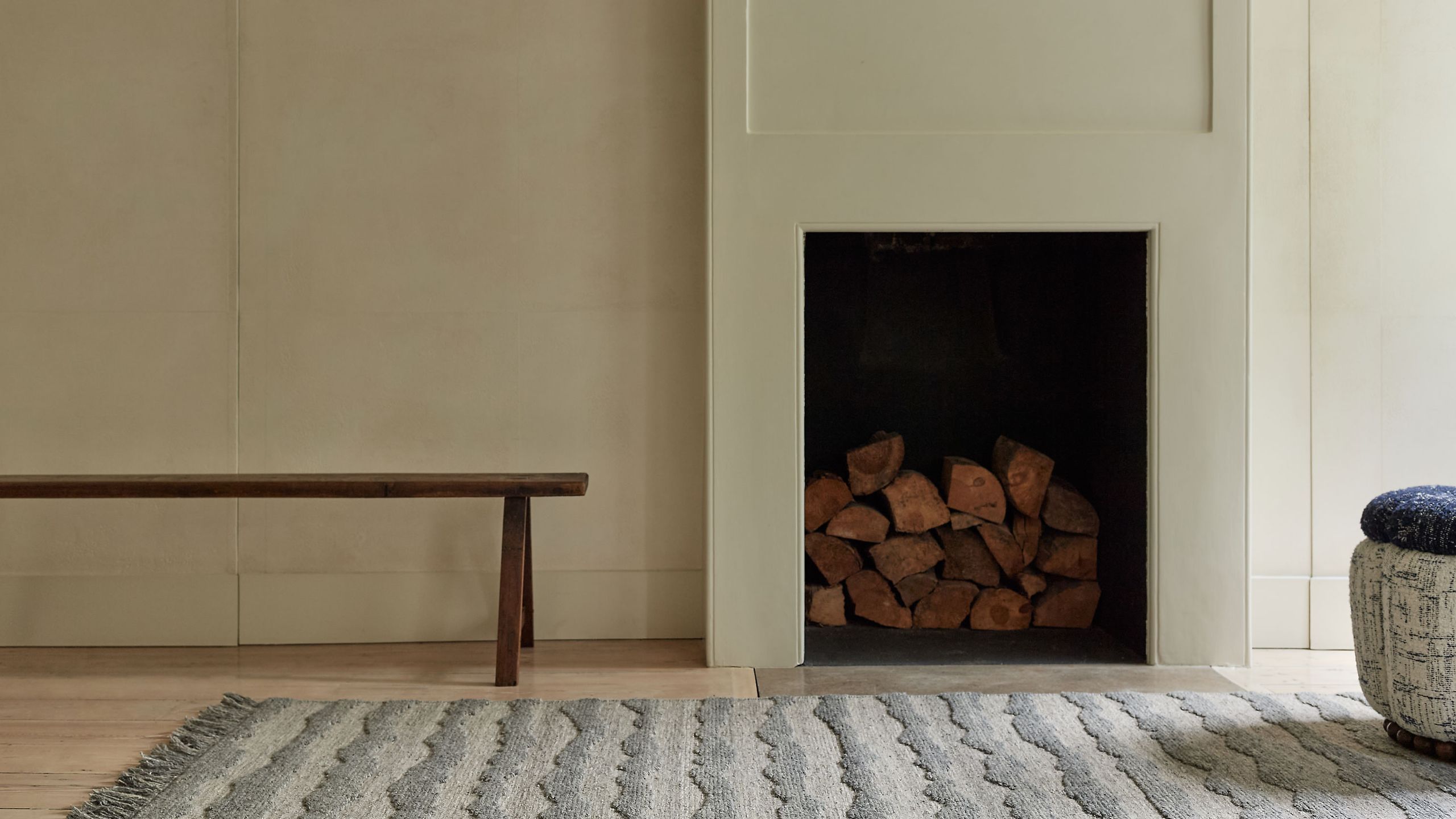 Image may contain: Fireplace, Indoors, Home Decor, Interior Design, Rug, and Hearth