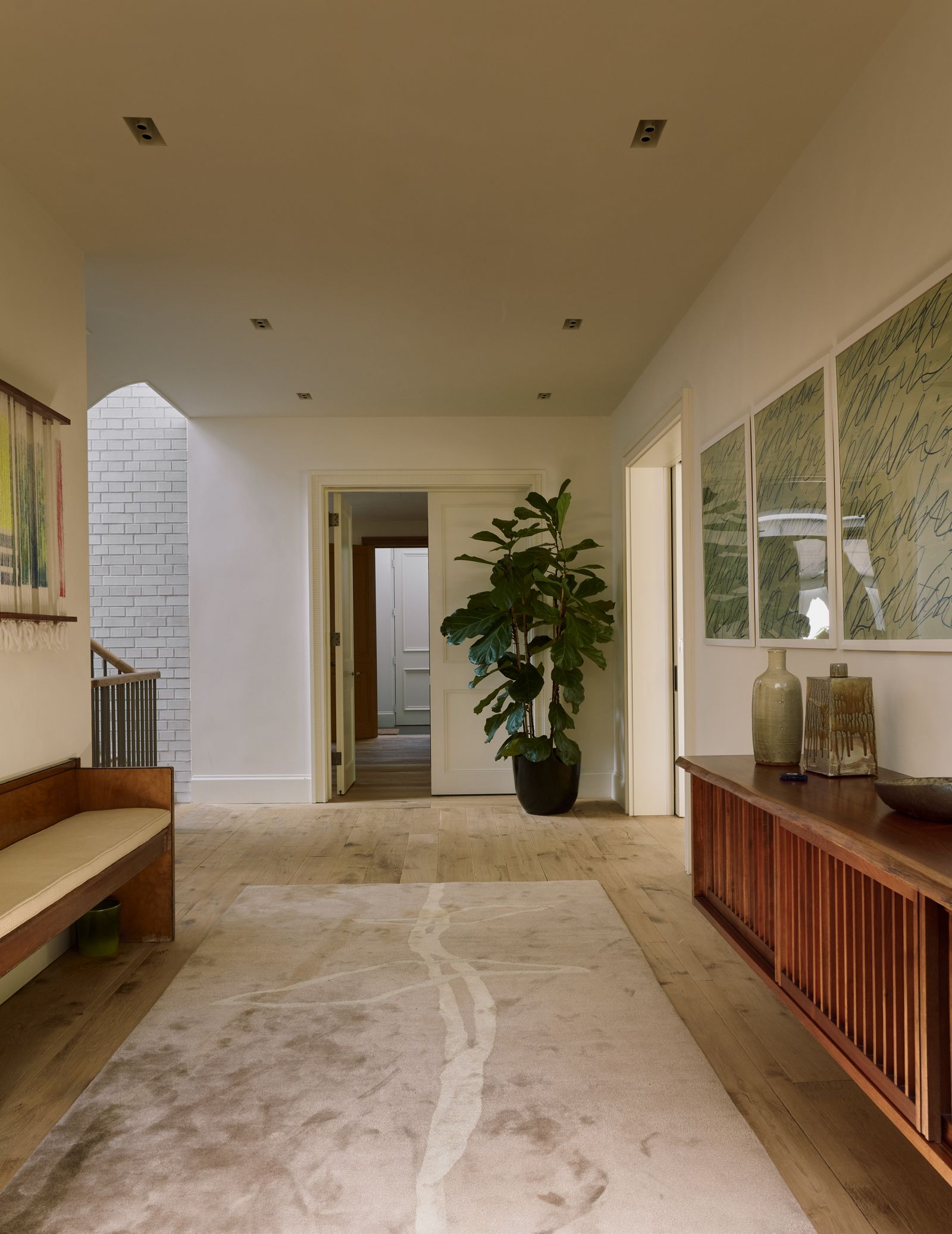 Image may contain Floor Flooring Indoors Interior Design Bench Furniture Plant Home Decor Rug and Wood