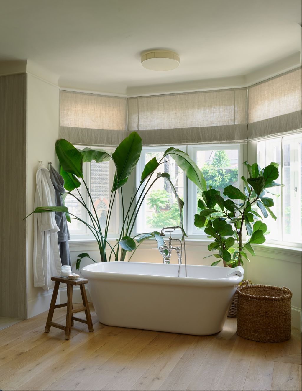 Image may contain Bathing Bathtub Person Tub Lamp Plant Window Indoors Interior Design and Bay Window