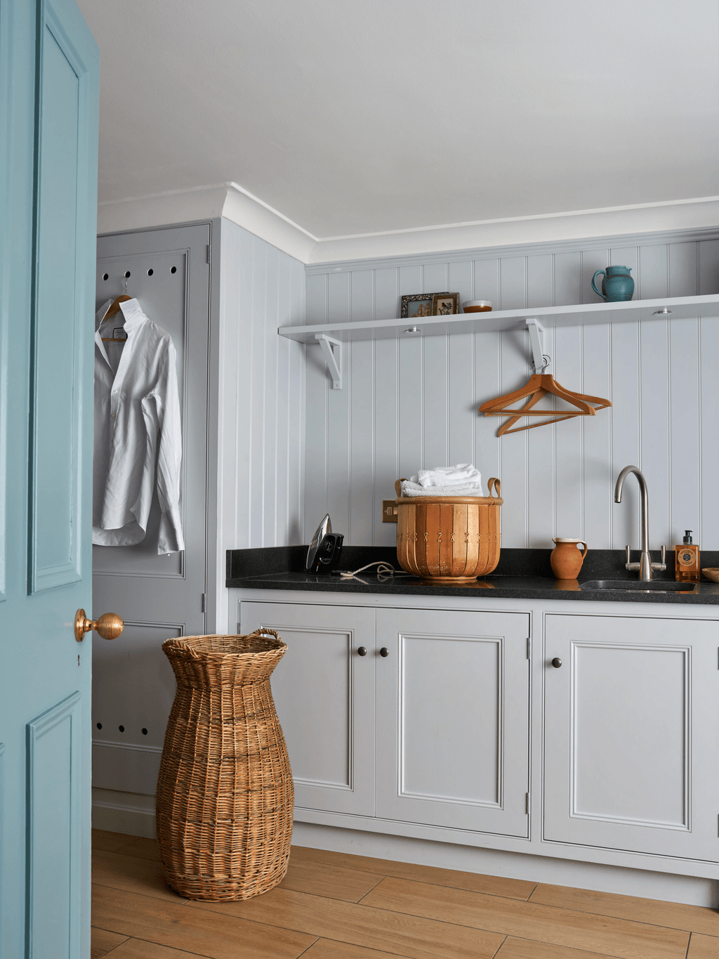 Image may contain Indoors Interior Design Sink Sink Faucet Clothing Coat Kitchen Shelf and Floor