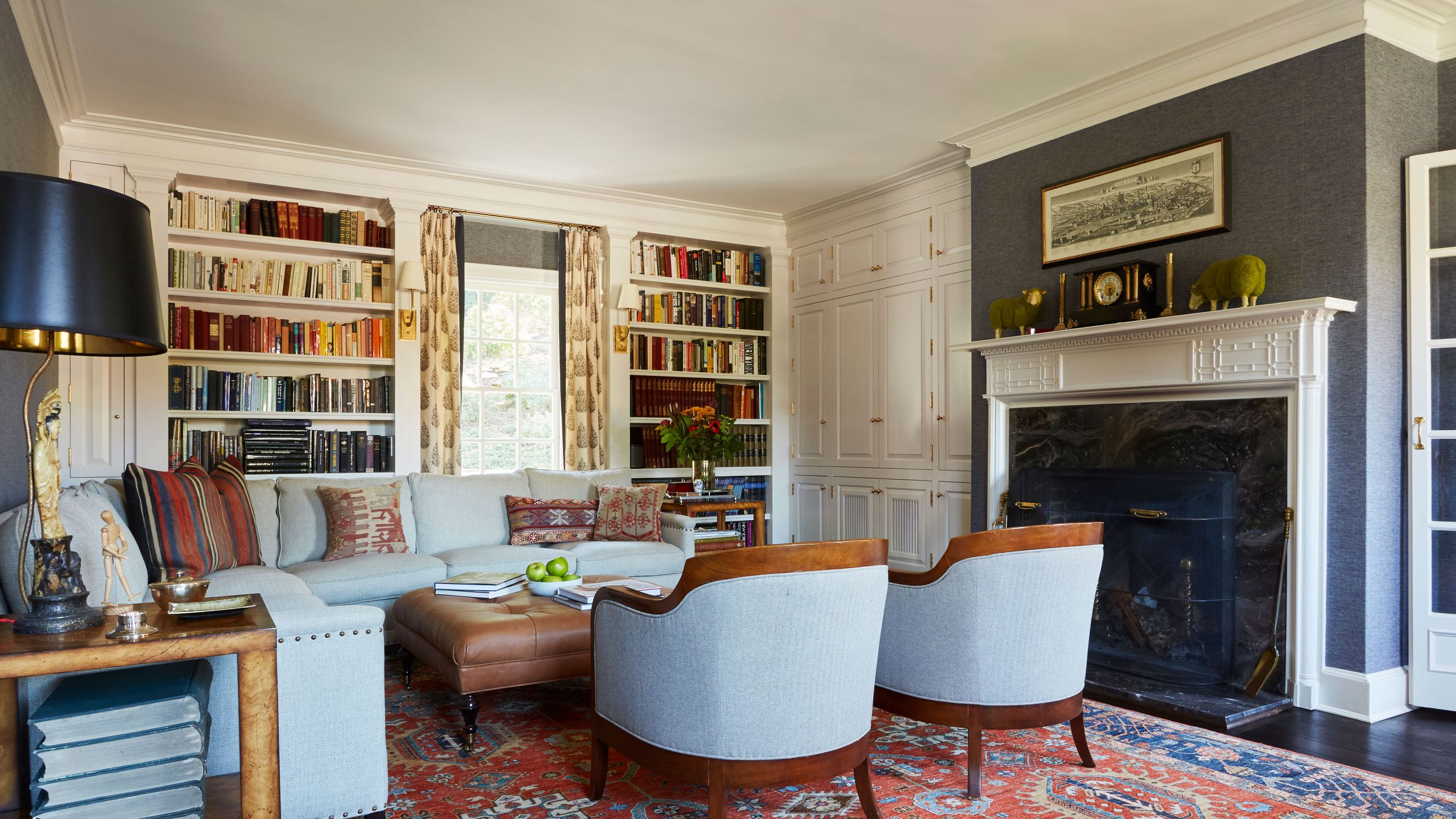 Image may contain: Home Decor, Lamp, Chair, Furniture, Art, Painting, Architecture, Building, Indoors, Living Room, and Room