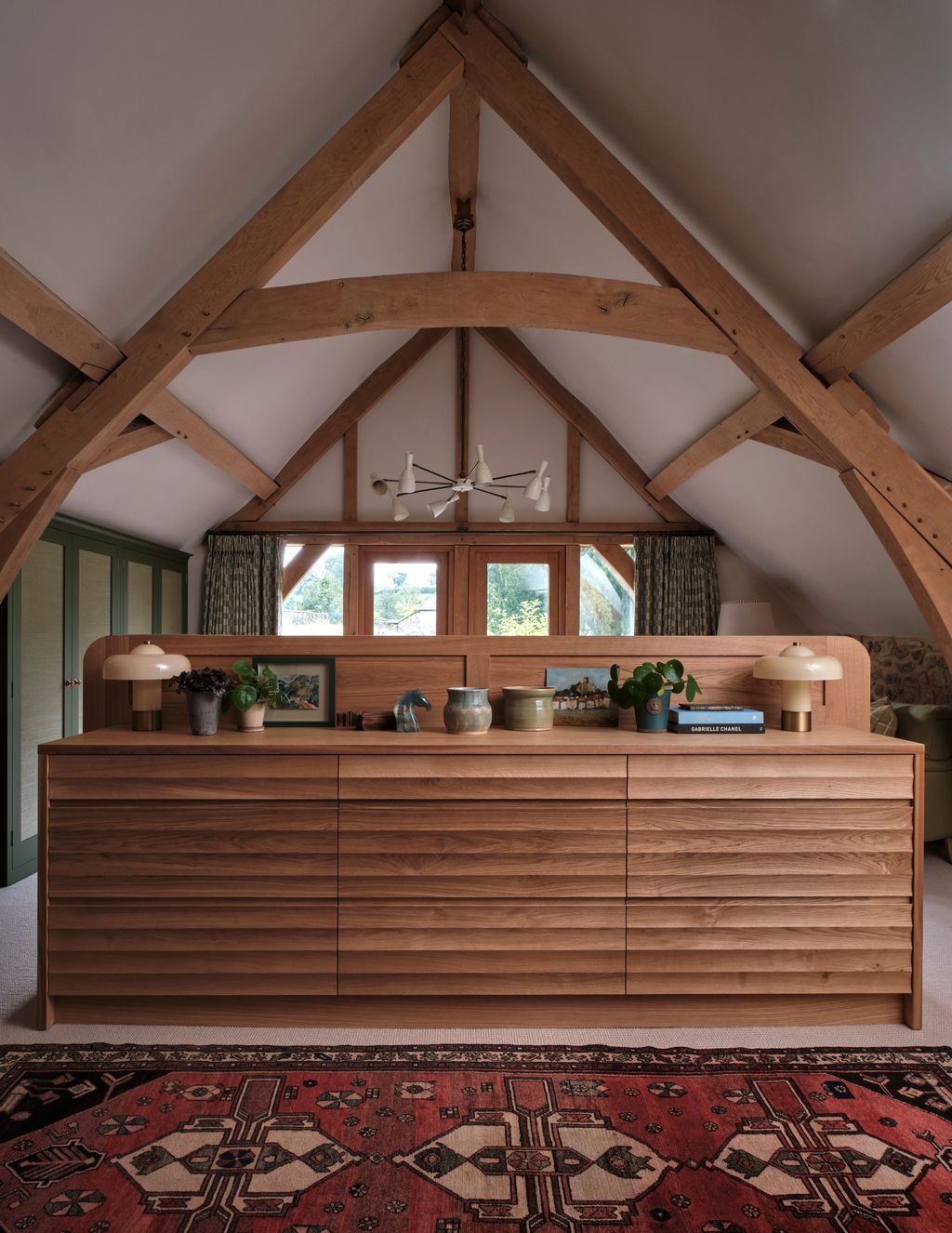 Image may contain Indoors Interior Design Lamp Plant Wood Furniture Sideboard Home Decor Rug and Hardwood