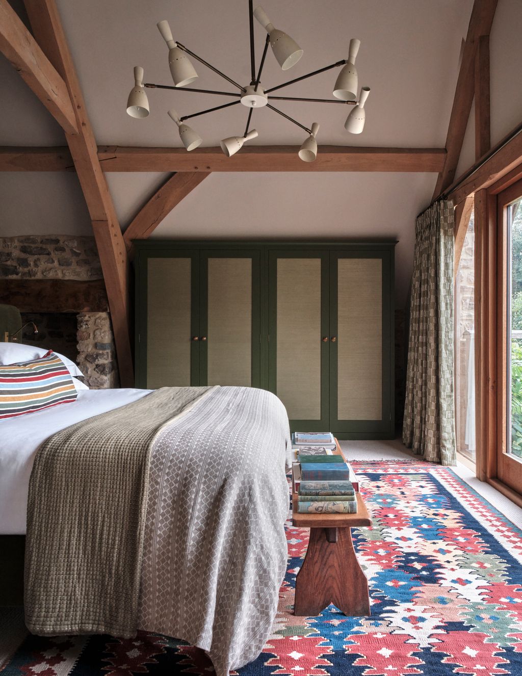 Image may contain Indoors Interior Design Home Decor Lamp Bed Furniture Rug Bedroom Room and Chandelier