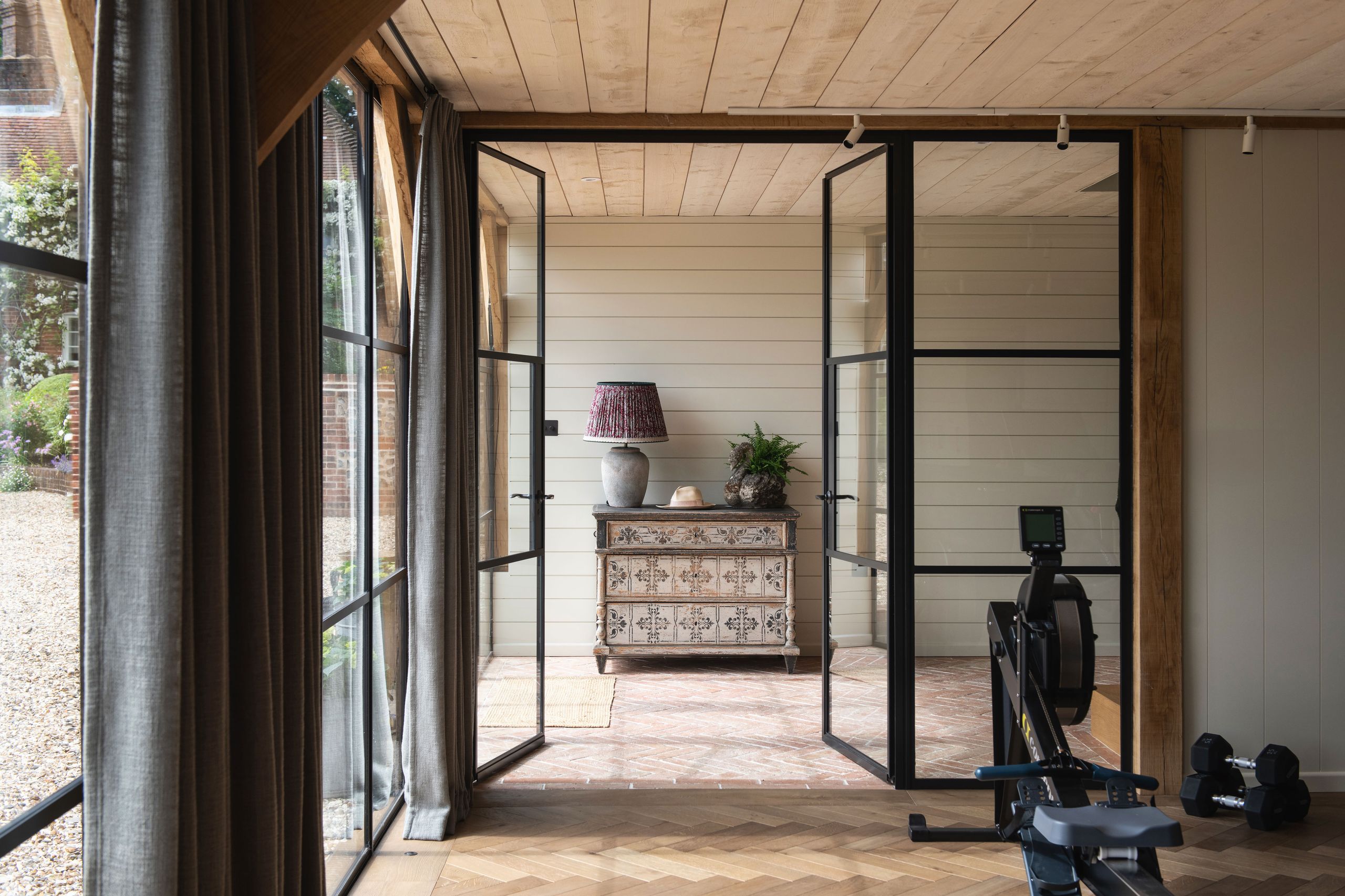 Image may contain: Door, Lamp, Plant, Indoors, Interior Design, Architecture, Building, Housing, Chair, Furniture, and House