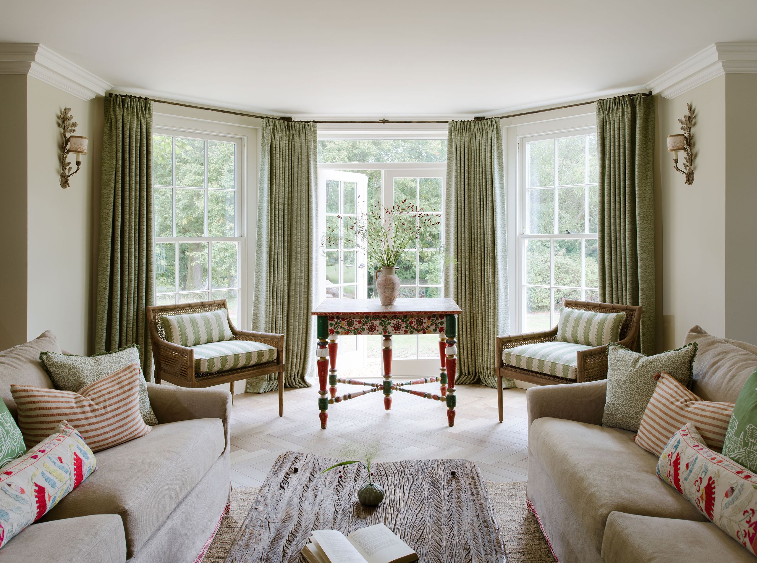 Image may contain: Book, Publication, Desk, Furniture, Table, Couch, Window, Home Decor, Rug, Chair, Lamp, and French Window