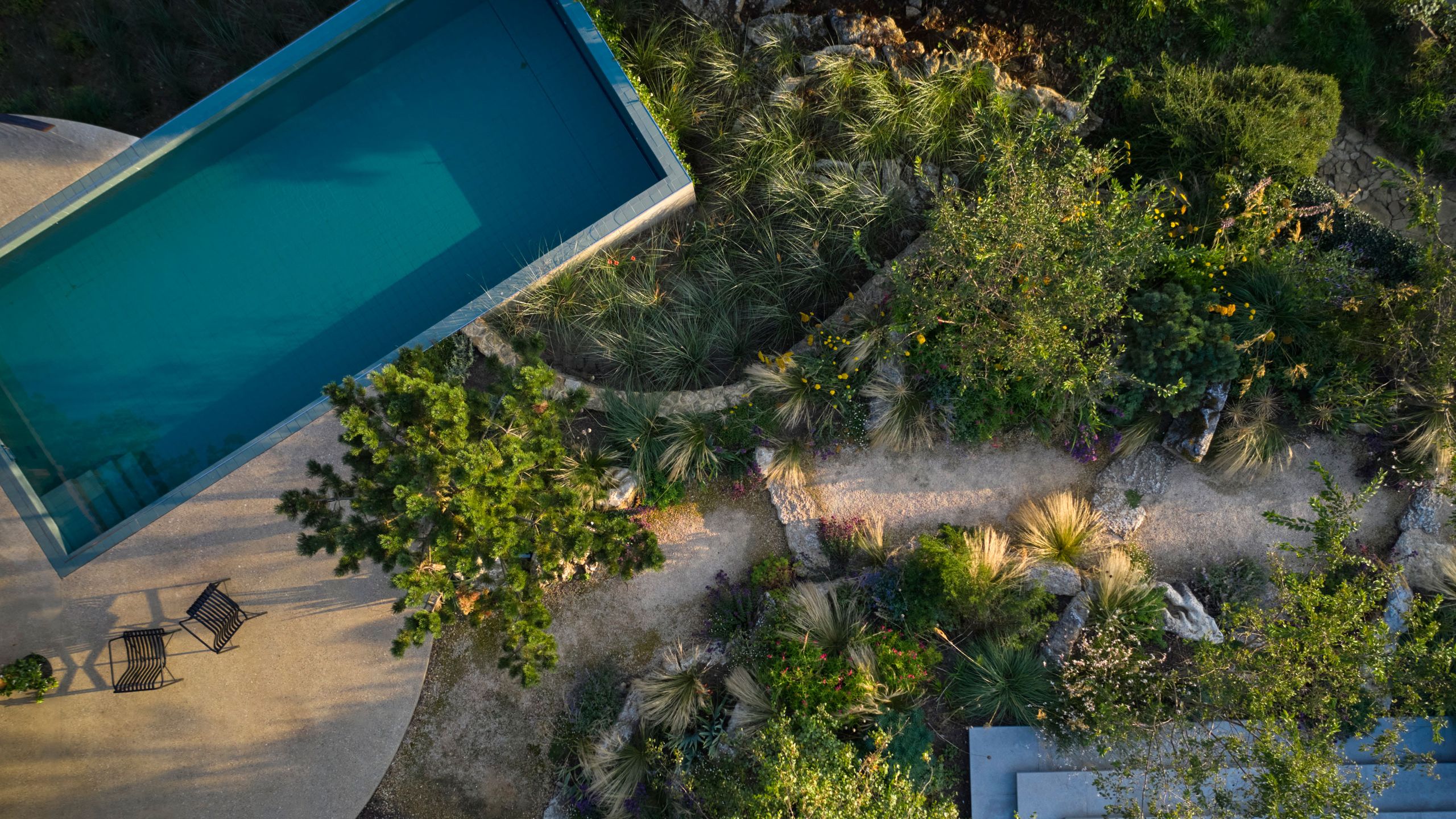 Image may contain: Pool, Water, Swimming Pool, Outdoors, Aerial View, Chair, and Furniture