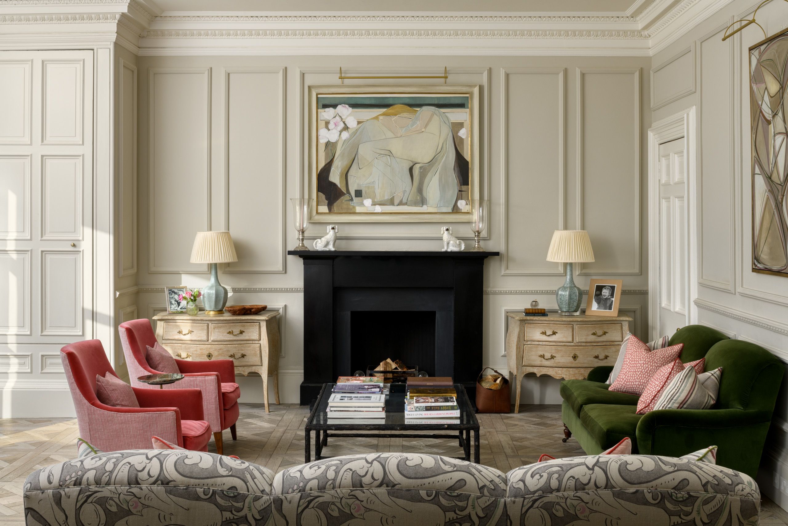 Image may contain: Lamp, Chair, Furniture, Home Decor, Art, Painting, Accessories, Bag, Handbag, Couch, and Fireplace