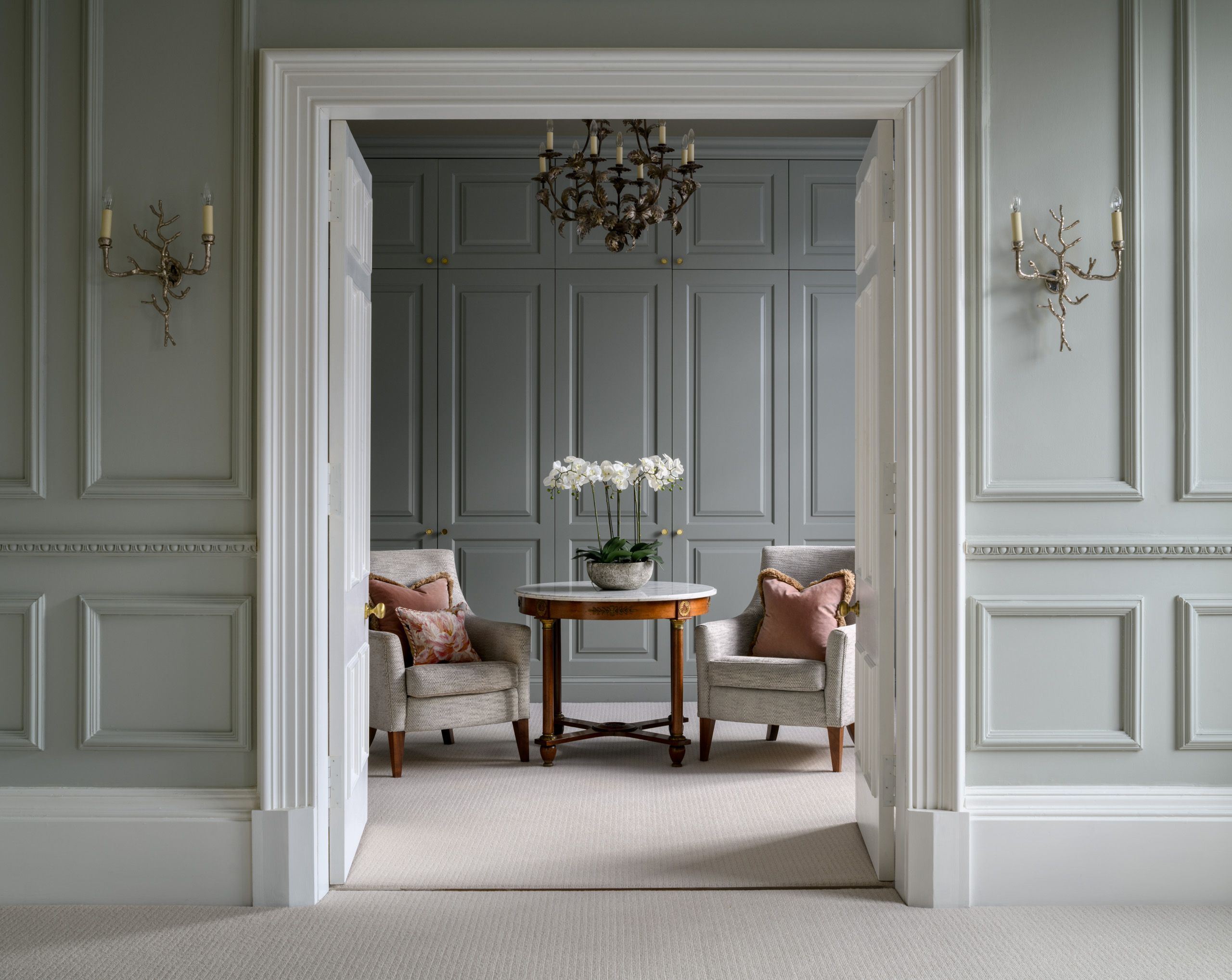 Image may contain: Indoors, Interior Design, Chandelier, Lamp, Door, Chair, Furniture, Architecture, Building, and Foyer