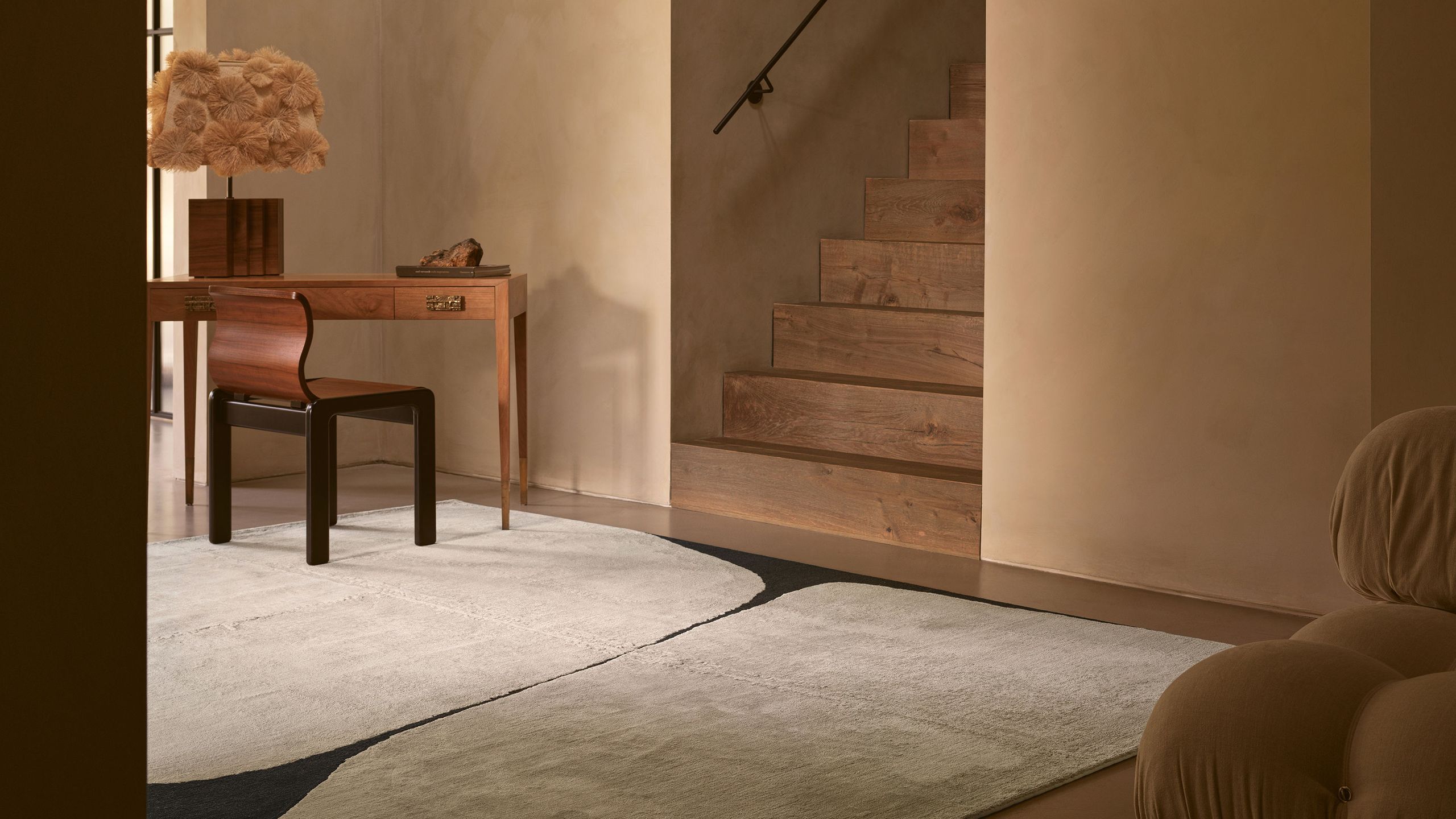 Image may contain: Home Decor, Rug, Chair, Furniture, Desk, Table, Lamp, Architecture, Building, House, and Housing