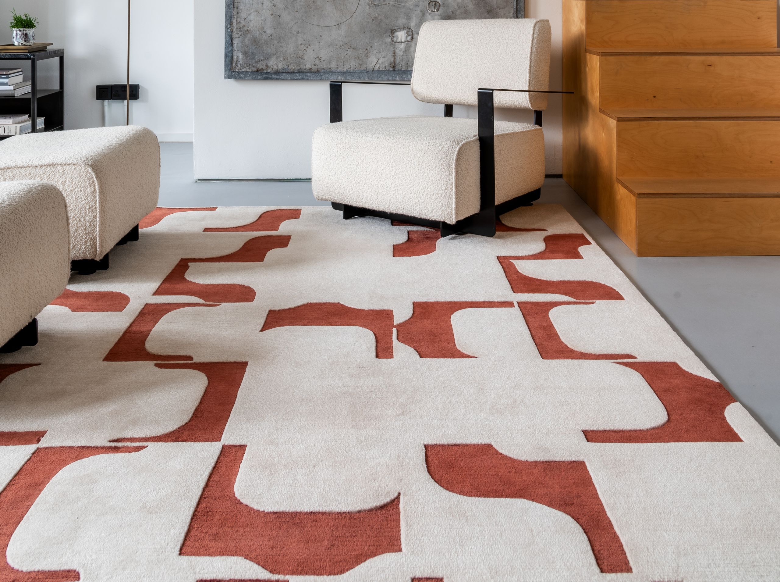 Image may contain: Home Decor, Rug, Plant, Chair, and Furniture