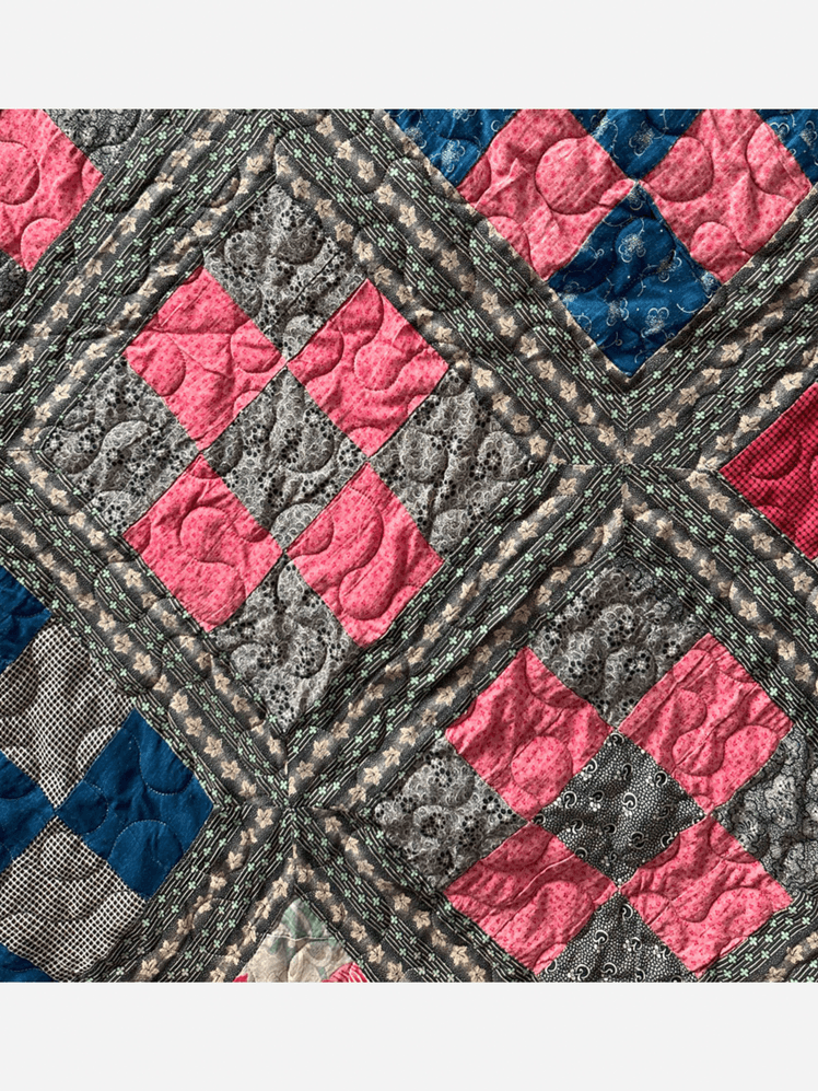 Image may contain: Quilt, Patchwork, Home Decor, and Pattern