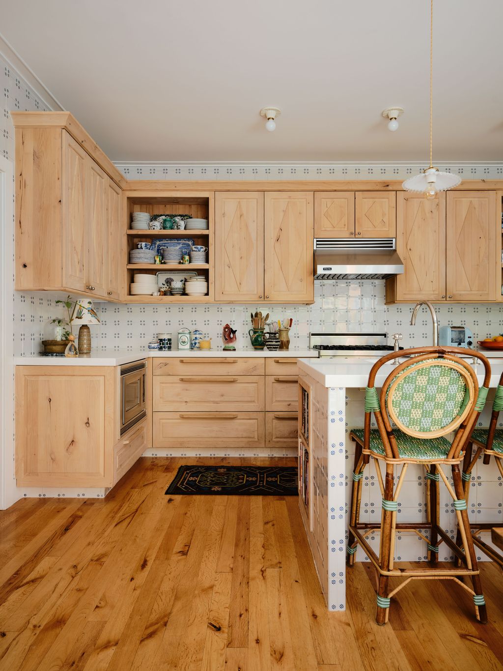 Image may contain Indoors Interior Design Wood Kitchen Floor Hardwood Lamp Chair Furniture Sink and Sink Faucet