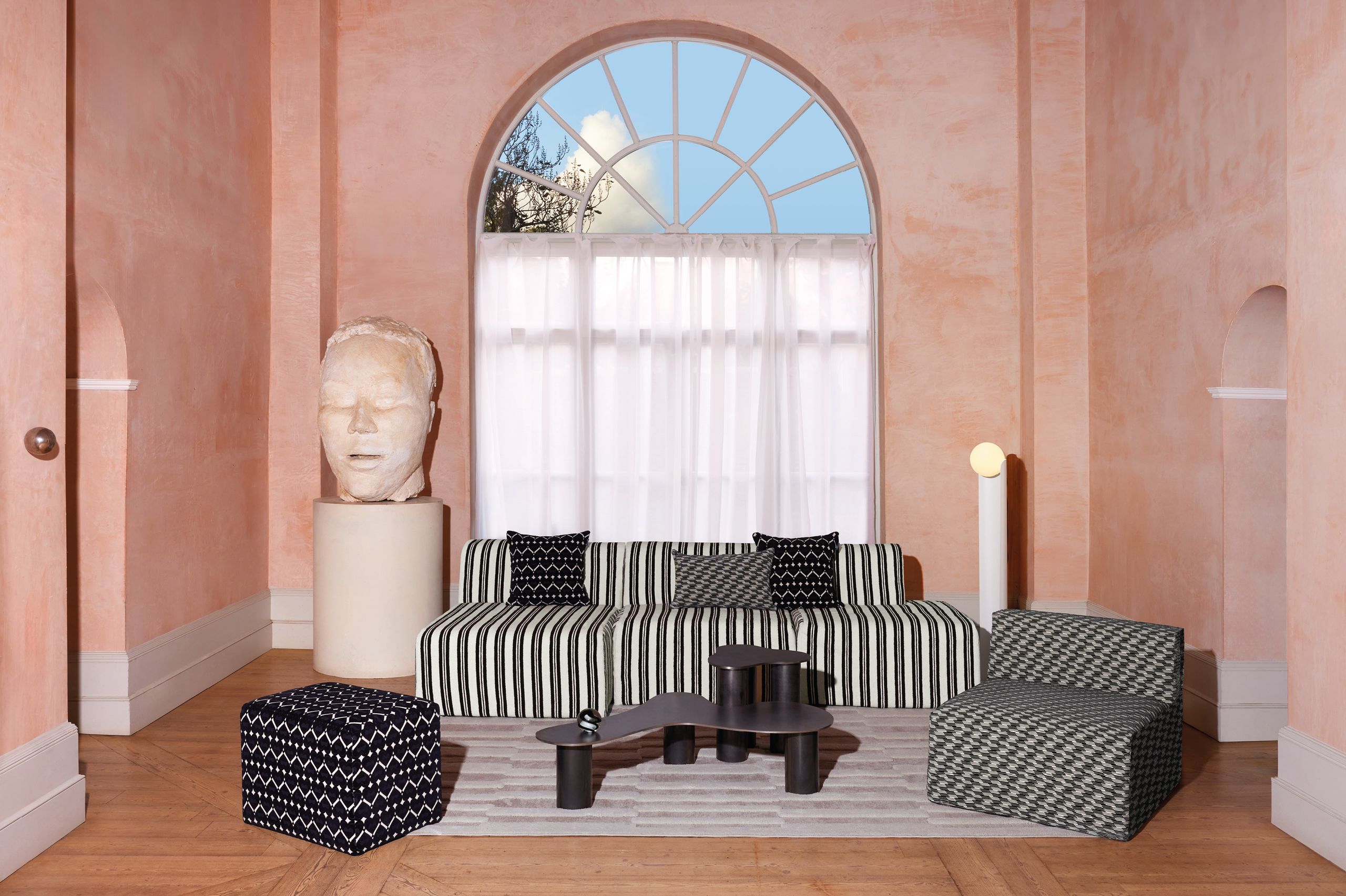 Image may contain: Home Decor, Couch, Furniture, Architecture, Building, Indoors, Living Room, Room, Person, and Cushion